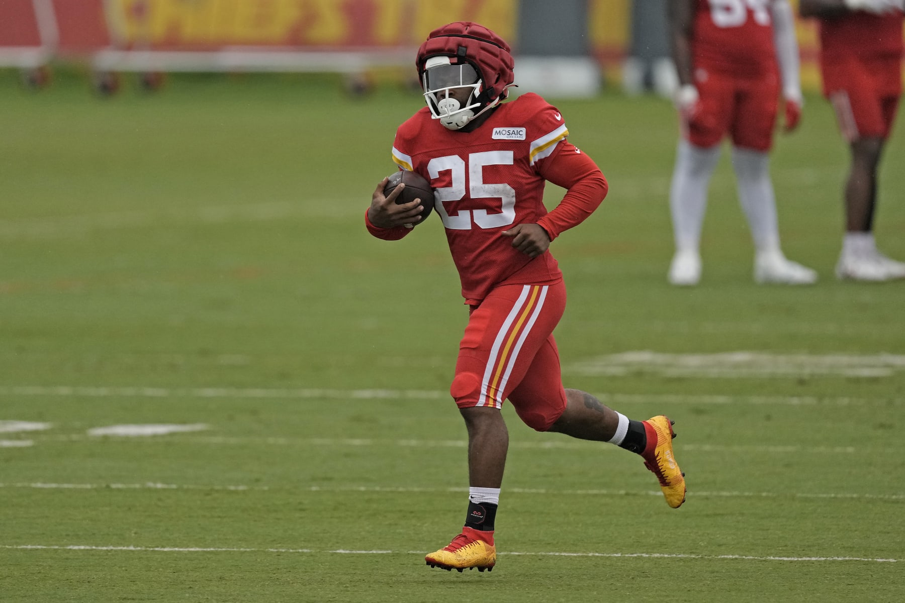 Kansas City Chiefs running back Clyde Edwards-Helaire runs the ball during NFL football training camp Friday, Aug. 4, 2023, in St. Joseph, Mo. (AP Photo/Charlie Riedel)