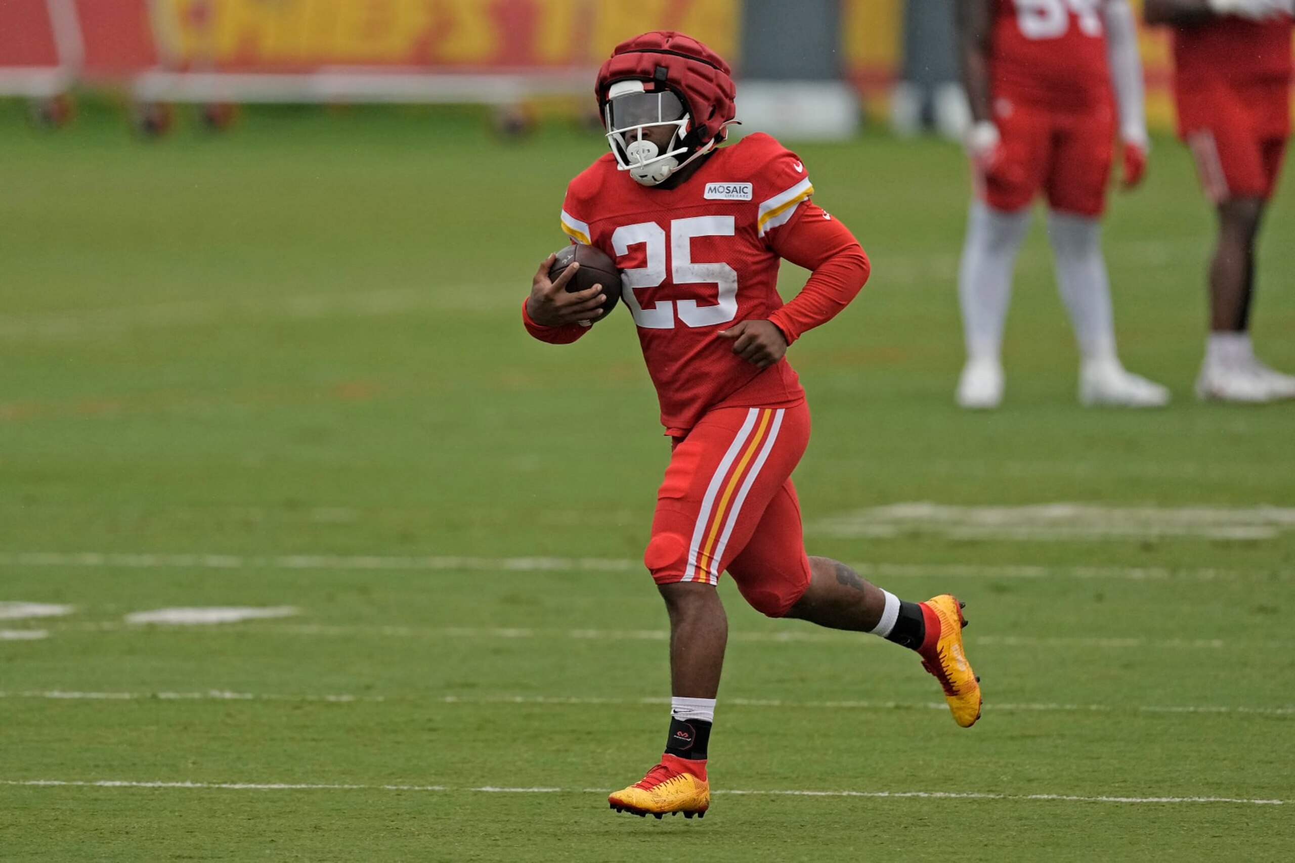 Kansas City Chiefs running back Clyde Edwards-Helaire runs the ball during NFL football training camp Friday, Aug. 4, 2023, in St. Joseph, Mo. (AP Photo/Charlie Riedel)