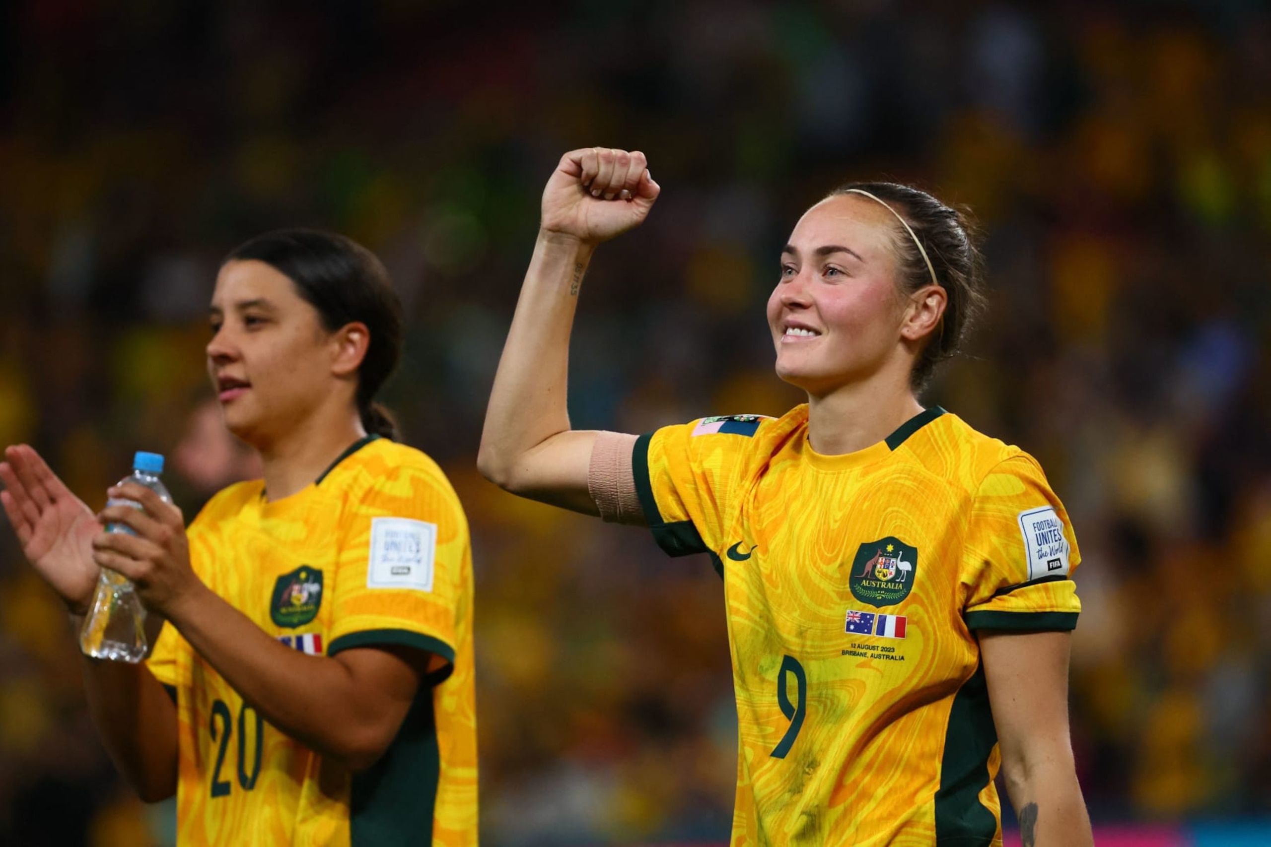 Australia's forward #20 Sam Kerr and Australia's forward #09 Caitlin Foord celebrate their team's victory after the end of the during the Australia and New Zealand 2023 Women's World Cup quarter-final football match between Australia and France at Brisbane Stadium in Brisbane on August 12, 2023. (Photo by Patrick Hamilton / AFP) (Photo by PATRICK HAMILTON/AFP via Getty Images)