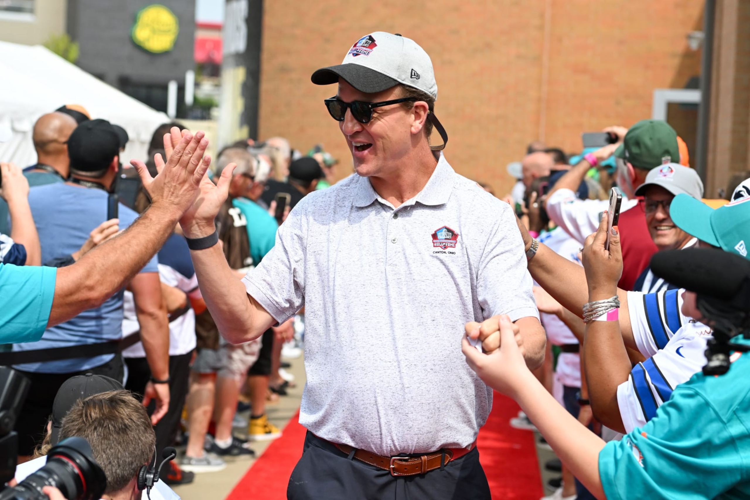 CANTON, OHIO - AUGUST 05: Hall of Fame quarterback Peyton Manning celebrates with fans as he is introduced prior to the 2023 Pro Football Hall of Fame Enshrinement Ceremony at Tom Benson Hall Of Fame Stadium on August 05, 2023 in Canton, Ohio. (Photo by Nick Cammett/Getty Images)
