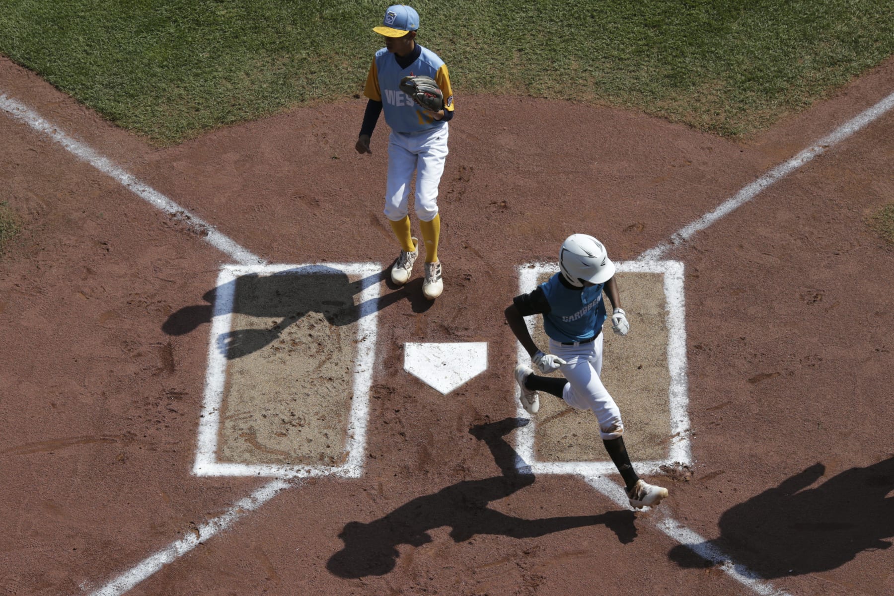 SOUTH WILLIAMSPORT, PENNSYLVANIA - AUGUST 28: Davey-Jay Rijke #8 of the Caribbean Region team from Willemstad, Curacao scores during the first inning of the Little League World Series Championship game against the West Region team from Honolulu, Hawaii at the Little League International Complex on August 28, 2022 in South Williamsport, Pennsylvania. (Photo by Joshua Bessex/Getty Images)