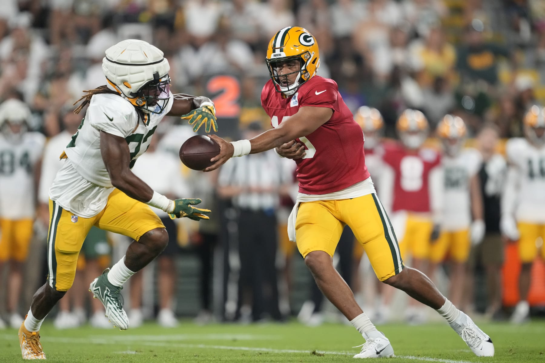 GREEN BAY, WISCONSIN - AUGUST 05: Jordan Love #10 of the Green Bay Packers hands the ball off to Aaron Jones #33 during Packers Family Night at Lambeau Field on August 05, 2023 in Green Bay, Wisconsin. (Photo by Patrick McDermott/Getty Images)