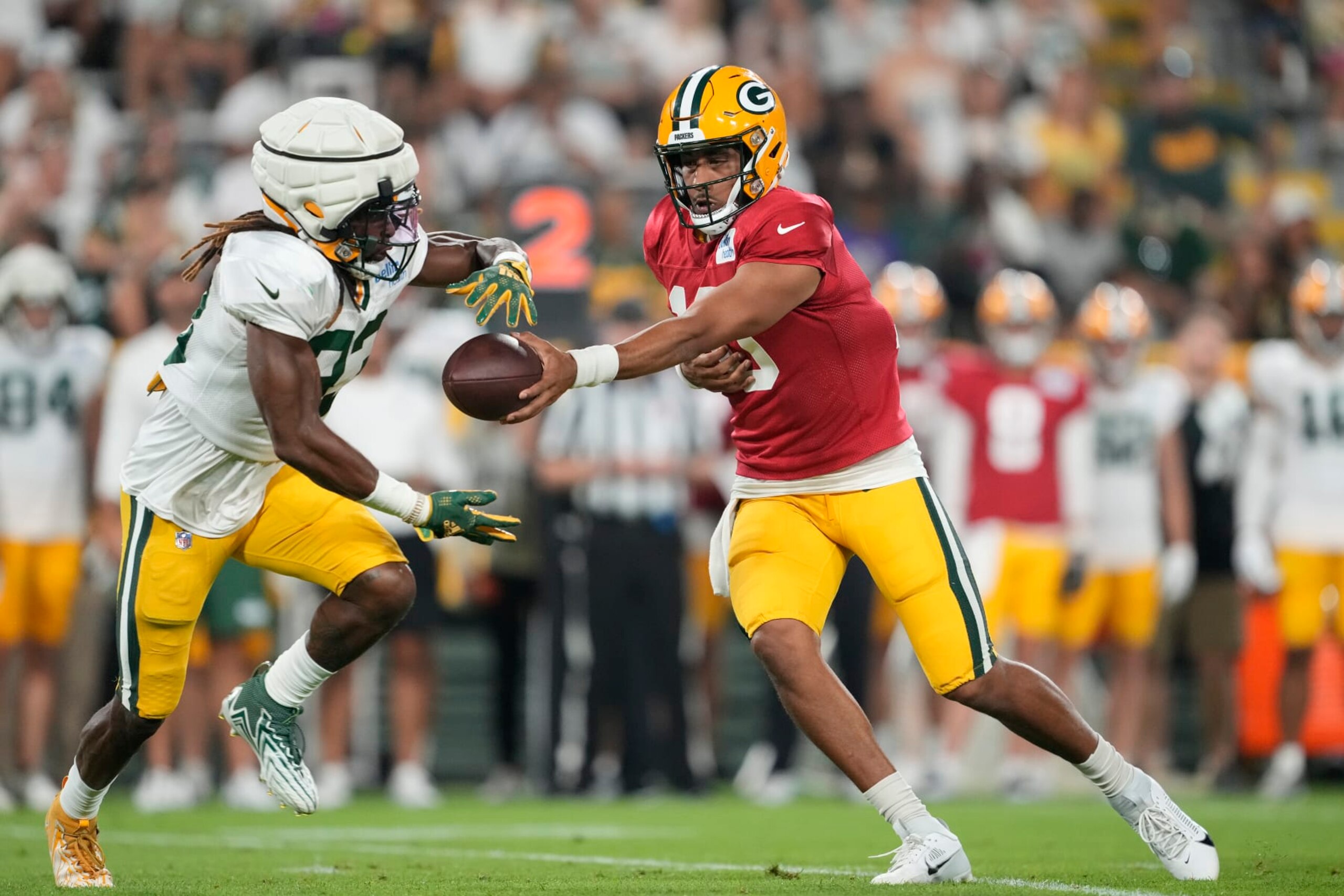 GREEN BAY, WISCONSIN - AUGUST 05: Jordan Love #10 of the Green Bay Packers hands the ball off to Aaron Jones #33 during Packers Family Night at Lambeau Field on August 05, 2023 in Green Bay, Wisconsin. (Photo by Patrick McDermott/Getty Images)