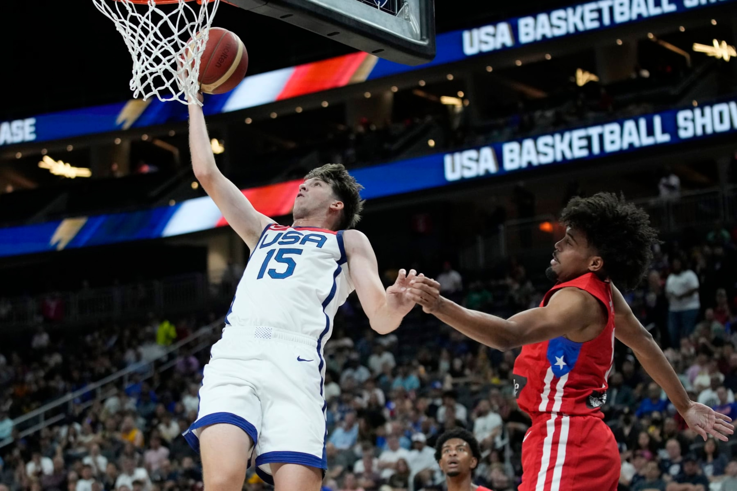 United States' Austin Reaves (15) shoots over Puerto Rico's Stephen Thompson Jr., right, during the first half of an exhibition basketball game Monday, Aug. 7, 2023, in Las Vegas. (AP Photo/John Locher) United States' Austin Reaves (15) shoots over Puerto Rico's Stephen Thompson Jr., right, during the first half of an exhibition basketball game Monday, Aug. 7, 2023, in Las Vegas. (AP Photo/John Locher)