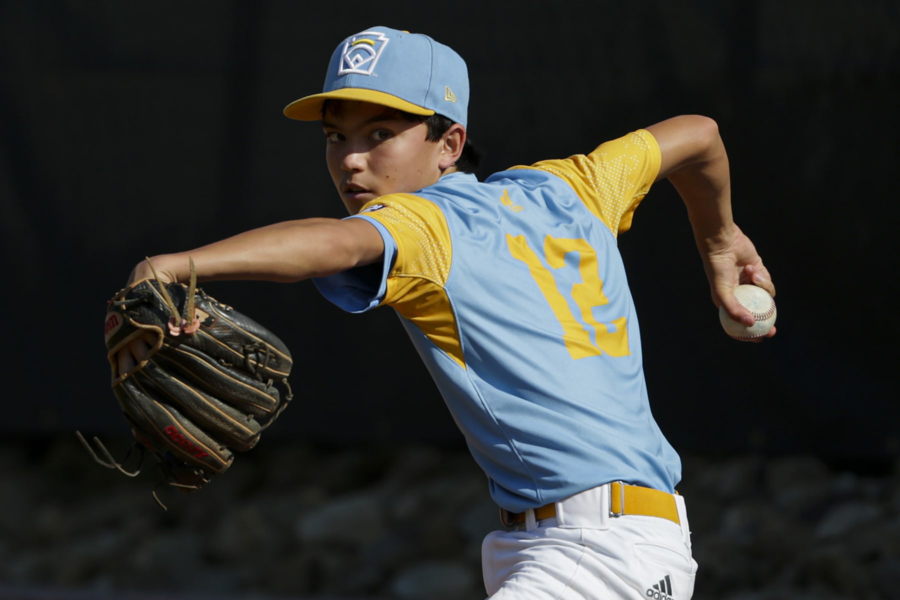 SOUTH WILLIAMSPORT, PENNSYLVANIA - AUGUST 28: Daly Watson #12 of the West Region team from Honolulu, Hawaii warms up in the bullpen during the third inning of the Little League World Series Championship game against the Caribbean Region team from Willemstad, Curacao at the Little League International Complex on August 28, 2022 in South Williamsport, Pennsylvania. (Photo by Joshua Bessex/Getty Images)