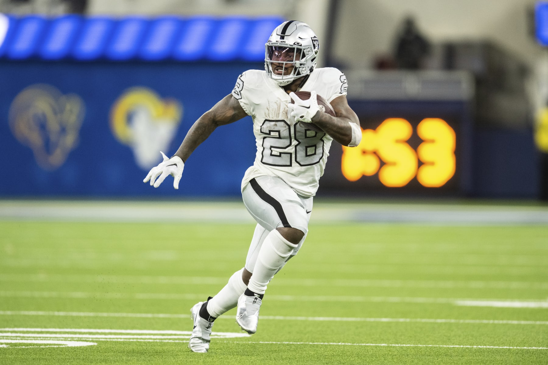 Las Vegas Raiders running back Josh Jacobs (28) runs with the ball during an NFL football game against the Los Angeles Rams, Thursday, Dec. 8, 2022, in Inglewood, Calif. (AP Photo/Kyusung Gong)