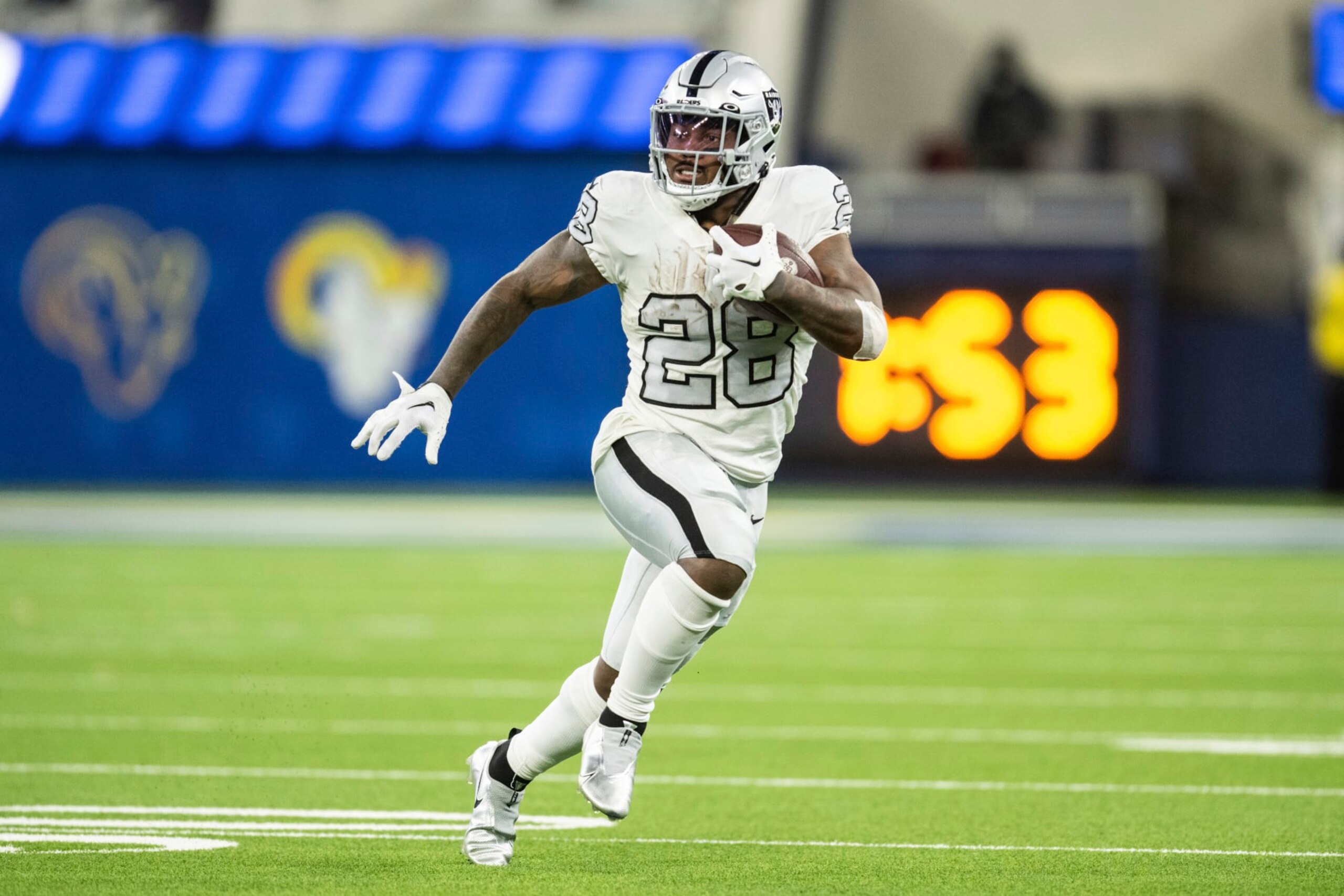 Las Vegas Raiders running back Josh Jacobs (28) runs with the ball during an NFL football game against the Los Angeles Rams, Thursday, Dec. 8, 2022, in Inglewood, Calif. (AP Photo/Kyusung Gong)