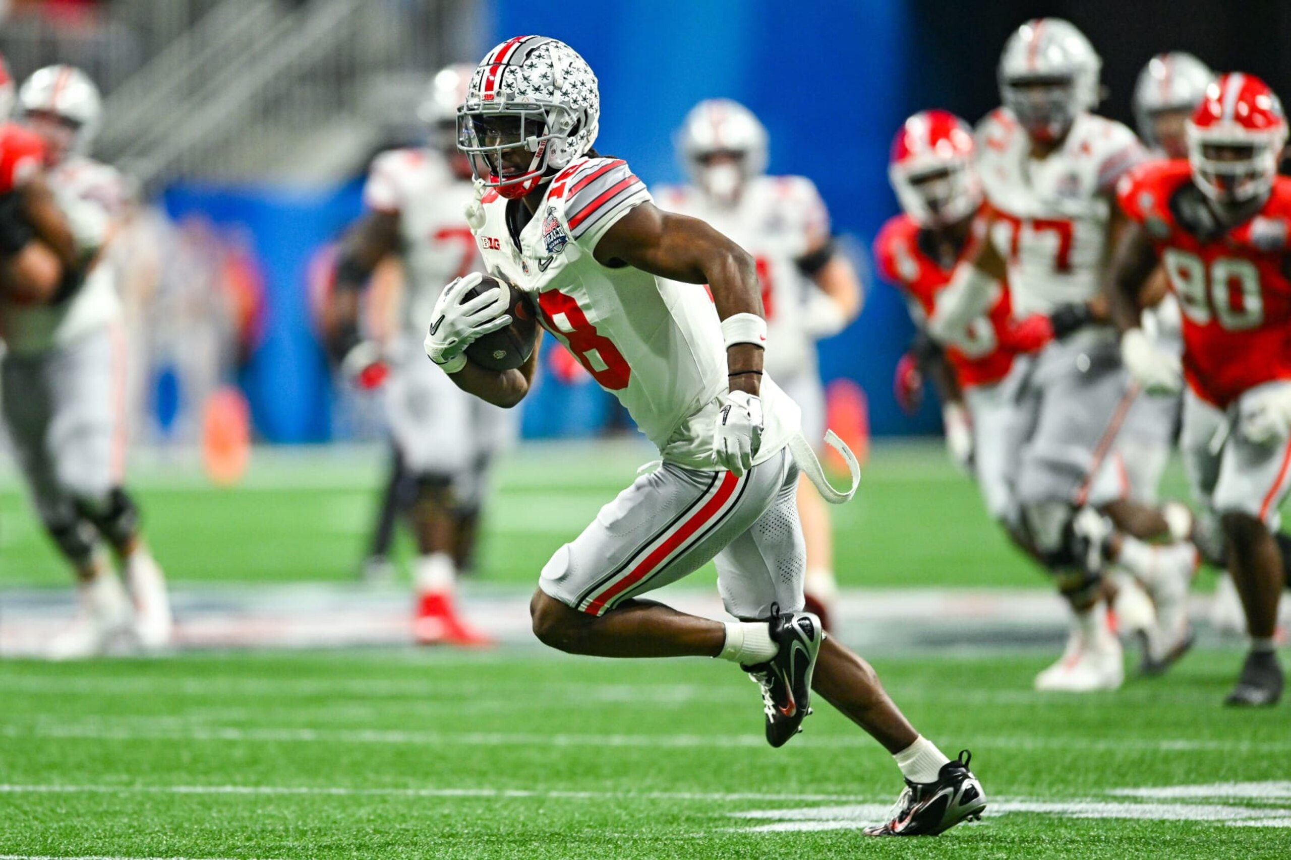 ATLANTA, GA  DECEMBER 31:  Ohio State wide receiver Marvin Harrison Jr. (18) runs with the ball during the Chick-fil-A Peach Bowl semi-final college football playoff between the Ohio State Buckeyes and the Georgia Bulldogs on December 31st, 2022 at Mercedes-Benz Stadium in Atlanta, GA.  (Photo by Rich von Biberstein/Icon Sportswire via Getty Images)