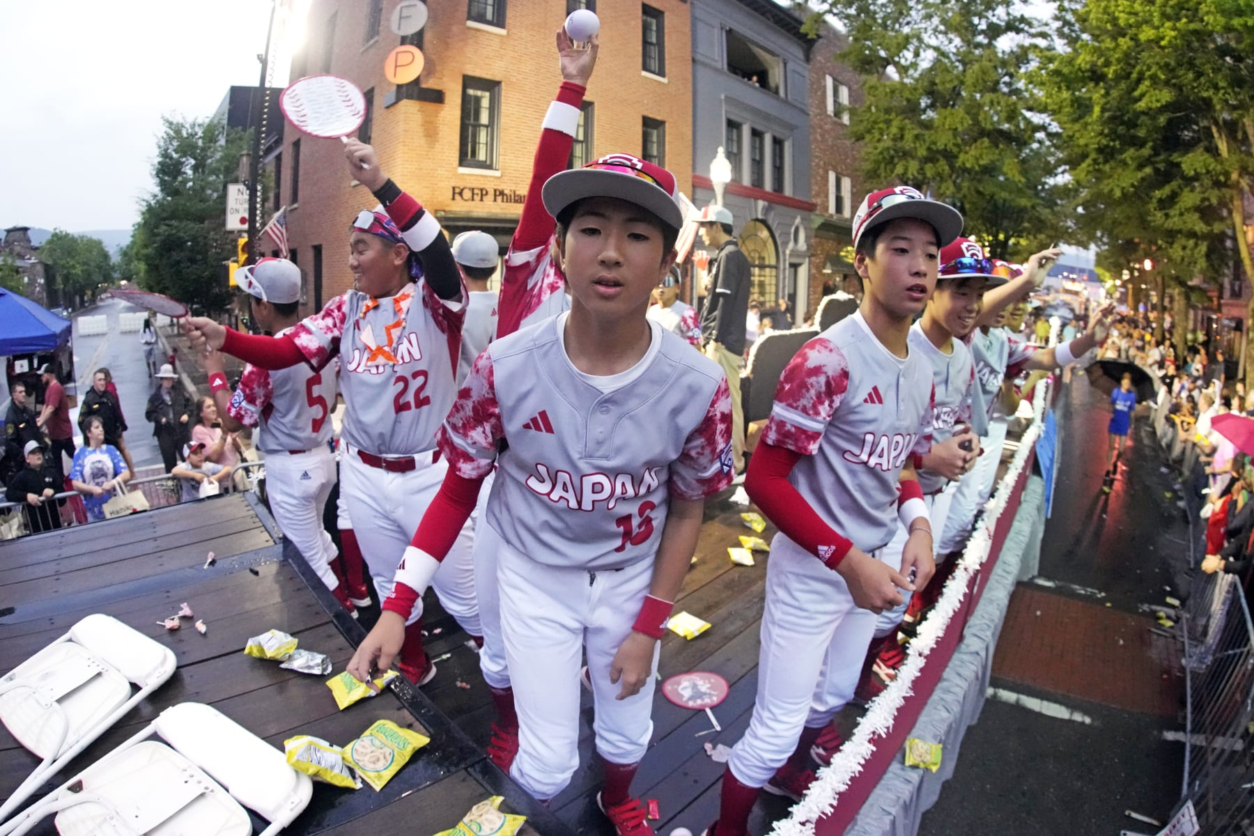 The Japan Region champion Little League team from Tokyo, Japan, rides in the Little League Grand Slam Parade in downtown Williamsport, Pa., Monday, Aug. 14, 2023. The Little League World Series baseball tournament, featuring 20 teams from around the world, starts later in the week in South Williamsport, Pa. (AP Photo/Gene J. Puskar)