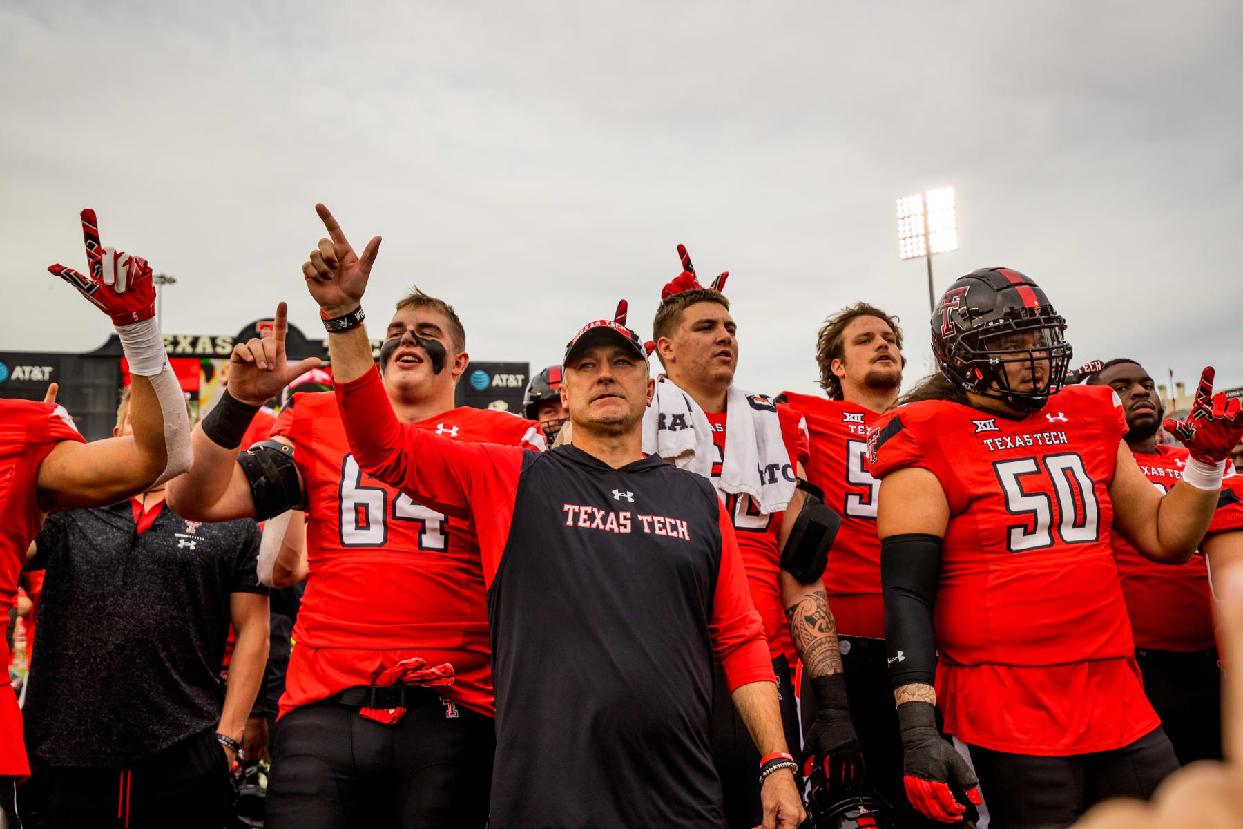 LUBBOCK, TEXAS - OCTOBER 22: Head coach Joey McGuire of the Texas Tech Red Raiders stands with players after the game against the West Virginia Mountaineers at Jones AT&T Stadium on October 22, 2022 in Lubbock, Texas. (Photo by John E. Moore III/Getty Images)
