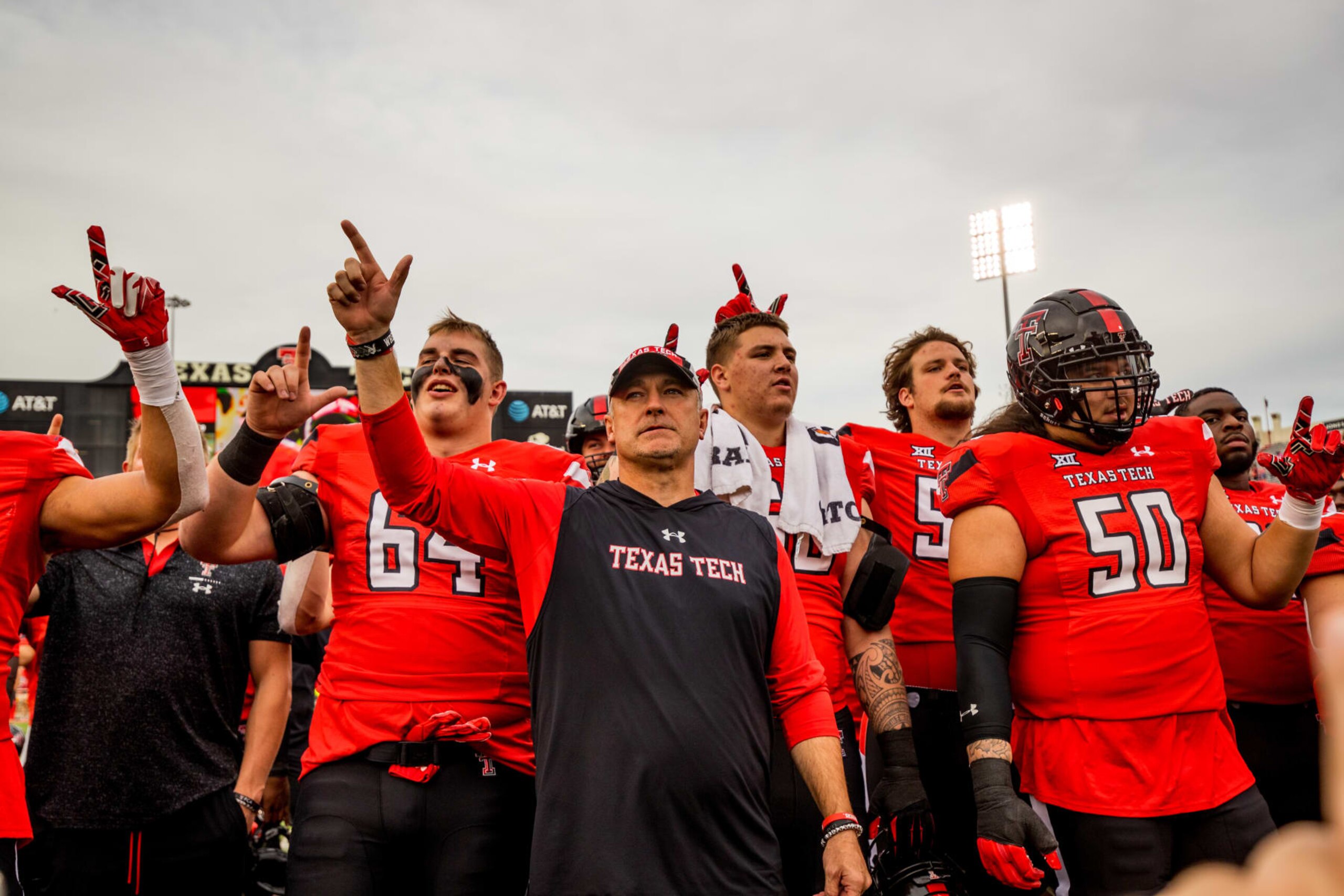 LUBBOCK, TEXAS - OCTOBER 22: Head coach Joey McGuire of the Texas Tech Red Raiders stands with players after the game against the West Virginia Mountaineers at Jones AT&T Stadium on October 22, 2022 in Lubbock, Texas. (Photo by John E. Moore III/Getty Images) LUBBOCK, TEXAS - OCTOBER 22: Head coach Joey McGuire of the Texas Tech Red Raiders stands with players after the game against the West Virginia Mountaineers at Jones AT&T Stadium on October 22, 2022 in Lubbock, Texas. (Photo by John E. Moore III/Getty Images)