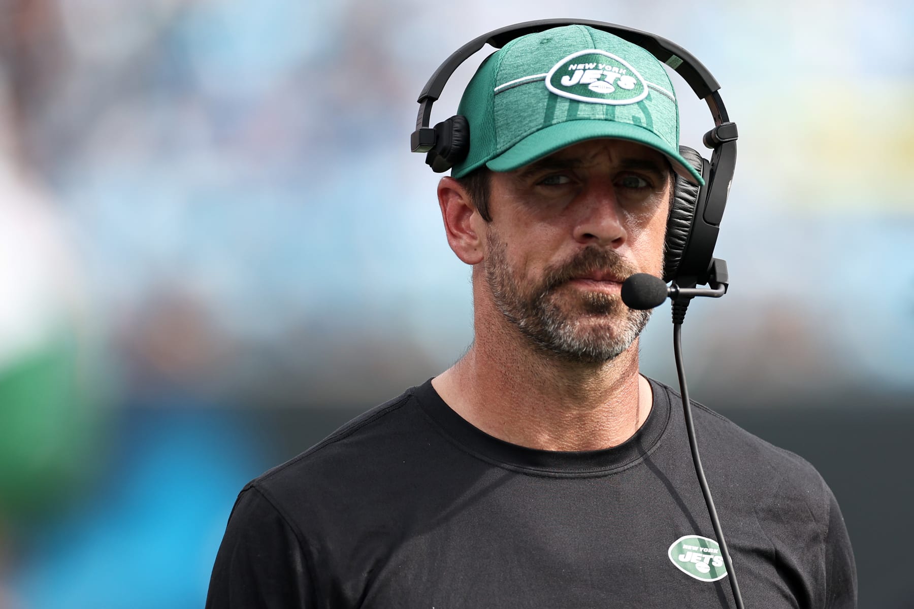 CHARLOTTE, NORTH CAROLINA - AUGUST 12: Aaron Rodgers #8 of the New York Jets looks on from the sideline during the second quarter of a preseason game against the Carolina Panthers at Bank of America Stadium on August 12, 2023 in Charlotte, North Carolina. (Photo by Jared C. Tilton/Getty Images) CHARLOTTE, NORTH CAROLINA - AUGUST 12: Aaron Rodgers #8 of the New York Jets looks on from the sideline during the second quarter of a preseason game against the Carolina Panthers at Bank of America Stadium on August 12, 2023 in Charlotte, North Carolina. (Photo by Jared C. Tilton/Getty Images)