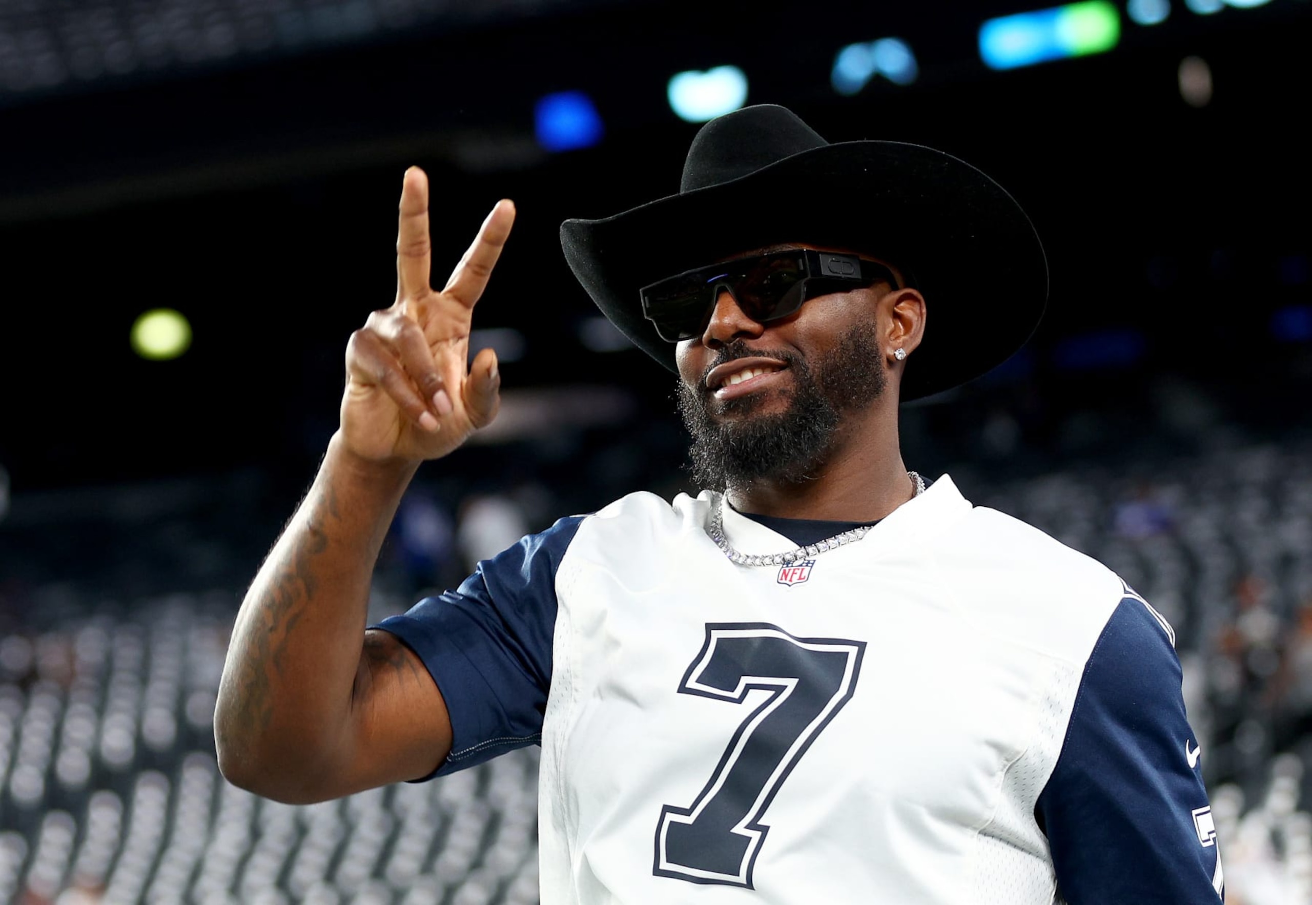 EAST RUTHERFORD, NEW JERSEY - SEPTEMBER 26:  Former Dallas Cowboys wide receiver Dez Bryant walks on the field before the game between the New York Giants and the Dallas Cowboys at MetLife Stadium on September 26, 2022 in East Rutherford, New Jersey. (Photo by Elsa/Getty Images)