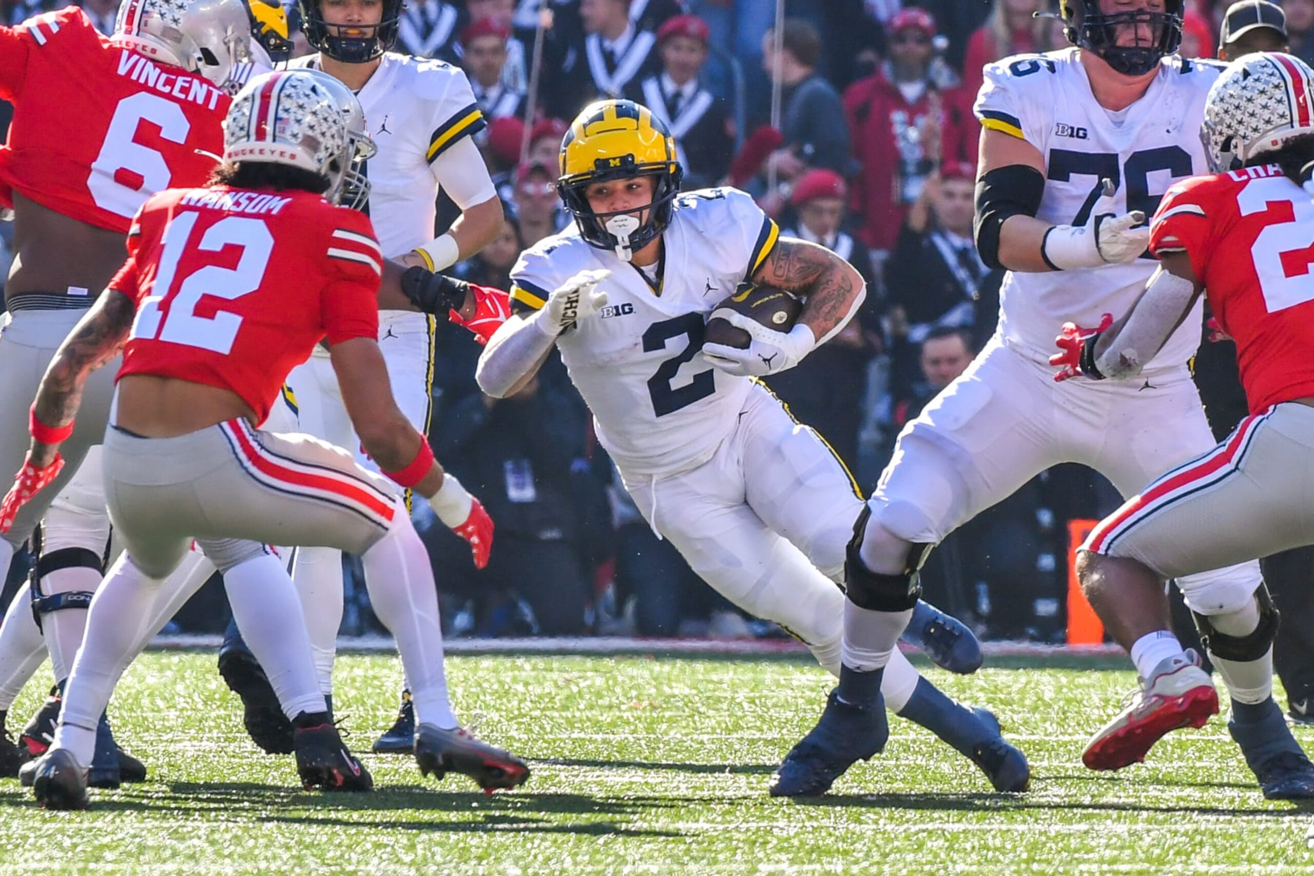 COLUMBUS, OHIO - NOVEMBER 26: Blake Corum #2 of the Michigan Wolverines runs with the ball as Lathan Ransom #12 of the Ohio State Buckeyes prepares to tackle him during the first half of a college football game at Ohio Stadium on November 26, 2022 in Columbus, Ohio. (Photo by Aaron J. Thornton/Getty Images)