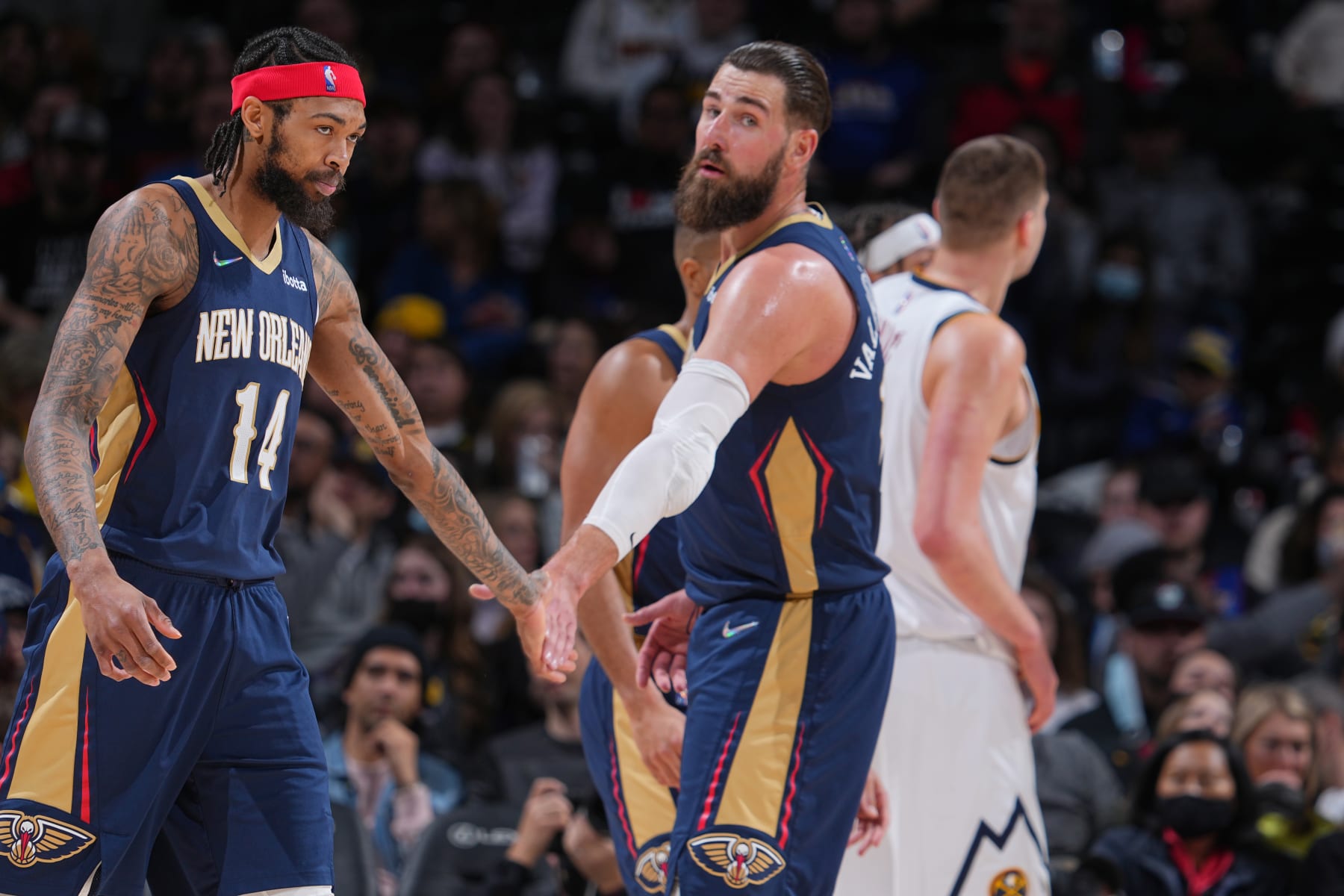 DENVER, CO - MARCH 6: Brandon Ingram #14 of the New Orleans Pelicans high fives Jonas Valanciunas #17 of the New Orleans Pelicans during the game against the Denver Nuggets on March 6, 2022 at the Ball Arena in Denver, Colorado. NOTE TO USER: User expressly acknowledges and agrees that, by downloading and/or using this Photograph, user is consenting to the terms and conditions of the Getty Images License Agreement. Mandatory Copyright Notice: Copyright 2022 NBAE (Photo by Bart Young/NBAE via Getty Images)