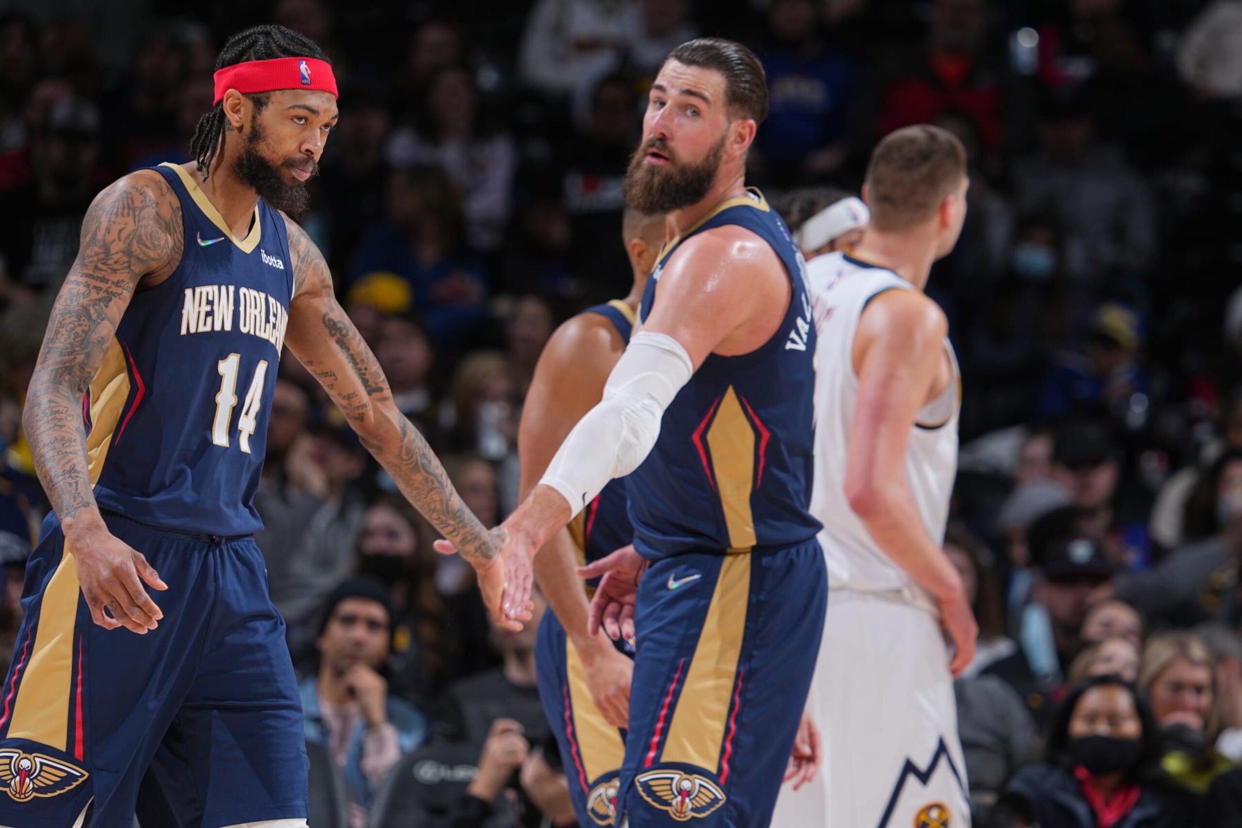 DENVER, CO - MARCH 6: Brandon Ingram #14 of the New Orleans Pelicans high fives Jonas Valanciunas #17 of the New Orleans Pelicans during the game against the Denver Nuggets on March 6, 2022 at the Ball Arena in Denver, Colorado. NOTE TO USER: User expressly acknowledges and agrees that, by downloading and/or using this Photograph, user is consenting to the terms and conditions of the Getty Images License Agreement. Mandatory Copyright Notice: Copyright 2022 NBAE (Photo by Bart Young/NBAE via Getty Images)
