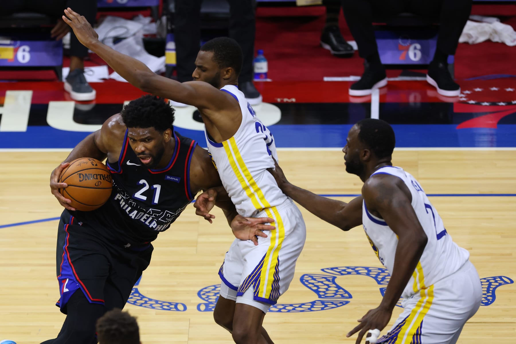 PHILADELPHIA, PA - APRIL 19: Joel Embiid #21 of the Philadelphia 76ers attempts a shot as Andrew Wiggins #22 of the Golden State Warriors defends during the second half of an NBA basketball game at Wells Fargo Center on April 19, 2021 in Philadelphia, Pennsylvania. The Warriors defeated the 76ers 107-96. (Photo by Rich Schultz/Getty Images)