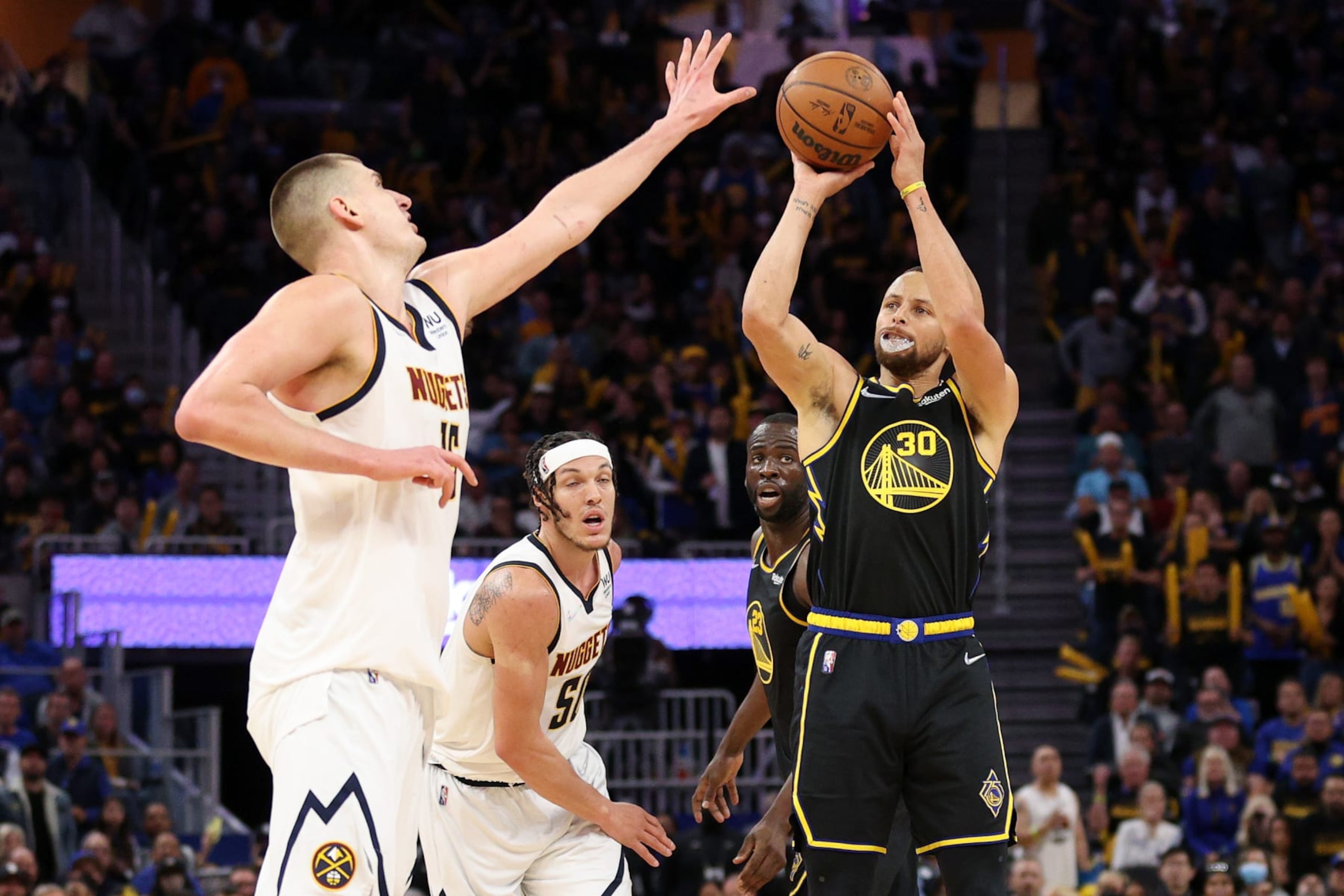 SAN FRANCISCO, CALIFORNIA - APRIL 27:  Stephen Curry #30 of the Golden State Warriors shoots over Nikola Jokic #15 of the Denver Nuggets in the second half during Game Five of the Western Conference First Round NBA Playoffs at Chase Center on April 27, 2022 in San Francisco, California. NOTE TO USER: User expressly acknowledges and agrees that, by downloading and/or using this photograph, User is consenting to the terms and conditions of the Getty Images License Agreement.  (Photo by Ezra Shaw/Getty Images)