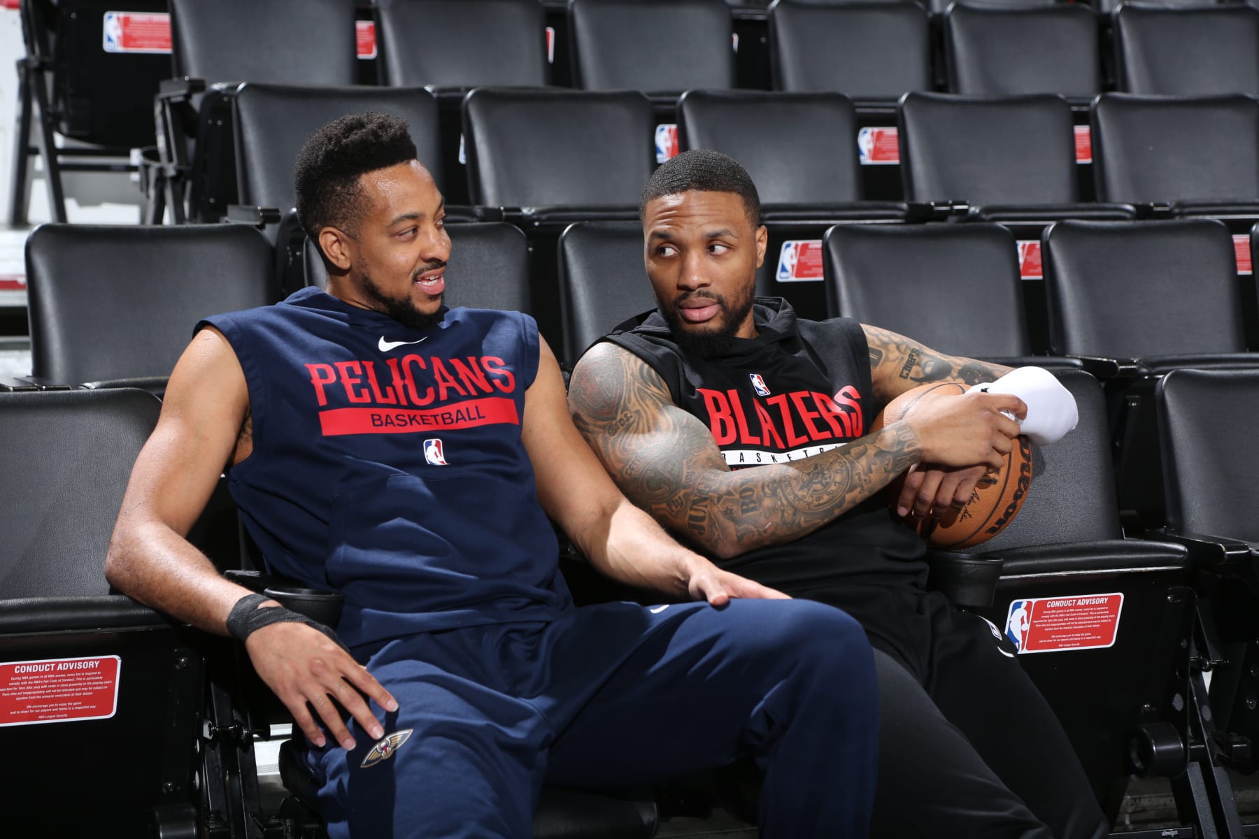 PORTLAND, OR - MARCH 27:  CJ McCollum #3 of the New Orleans Pelicans and Damian Lillard #0 of the Portland Trail Blazers looks on before the game on March 27, 2023 at the Moda Center Arena in Portland, Oregon. NOTE TO USER: User expressly acknowledges and agrees that, by downloading and or using this photograph, user is consenting to the terms and conditions of the Getty Images License Agreement. Mandatory Copyright Notice: Copyright 2023 NBAE (Photo by Sam Forencich/NBAE via Getty Images)
