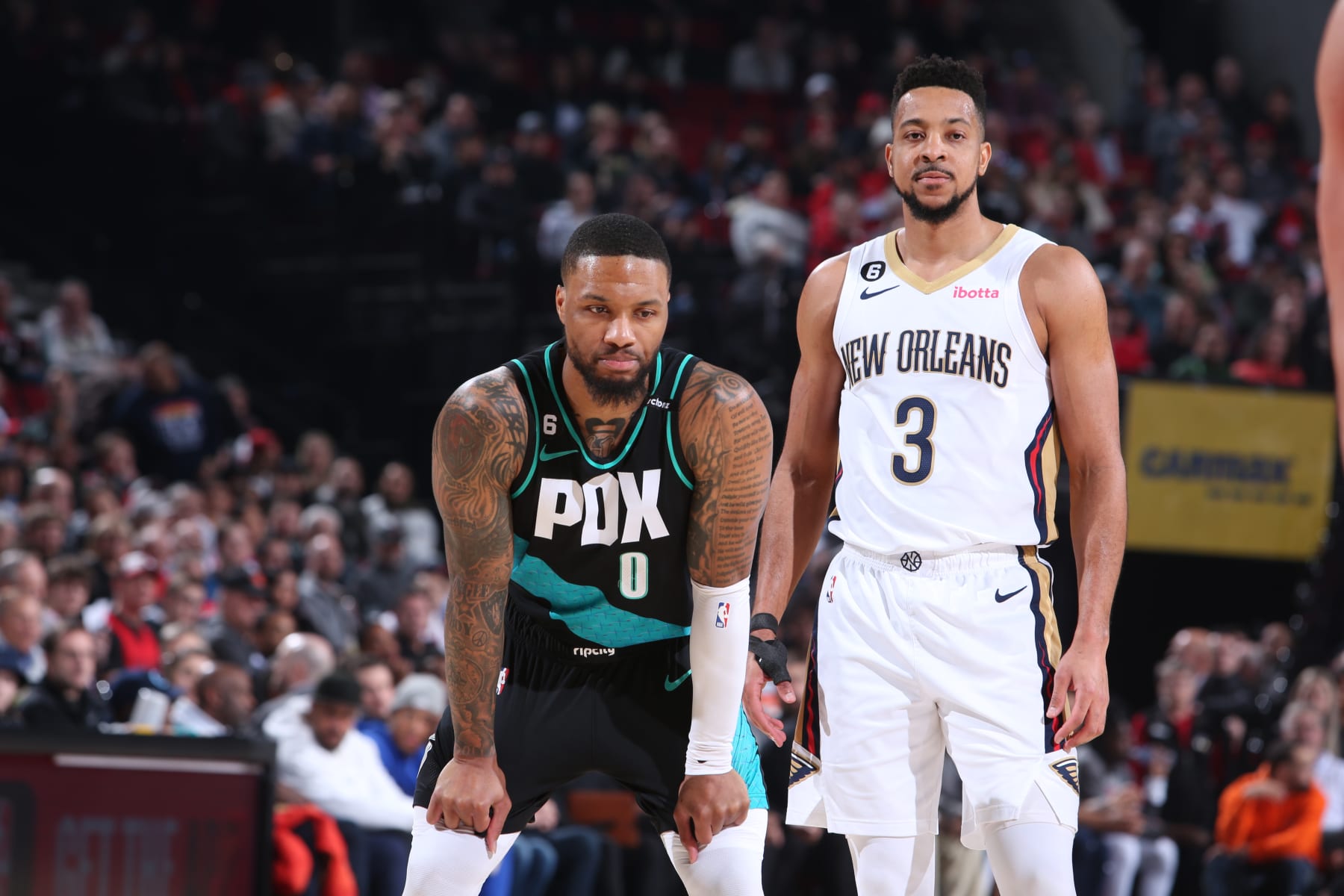 PORTLAND, OR - MARCH 1:  Damian Lillard #0 of the Portland Trail Blazers and CJ McCollum #3 of the New Orleans Pelicans looks on during the game on March 1, 2023 at the Moda Center Arena in Portland, Oregon. NOTE TO USER: User expressly acknowledges and agrees that, by downloading and or using this photograph, user is consenting to the terms and conditions of the Getty Images License Agreement. Mandatory Copyright Notice: Copyright 2023 NBAE (Photo by Sam Forencich/NBAE via Getty Images)