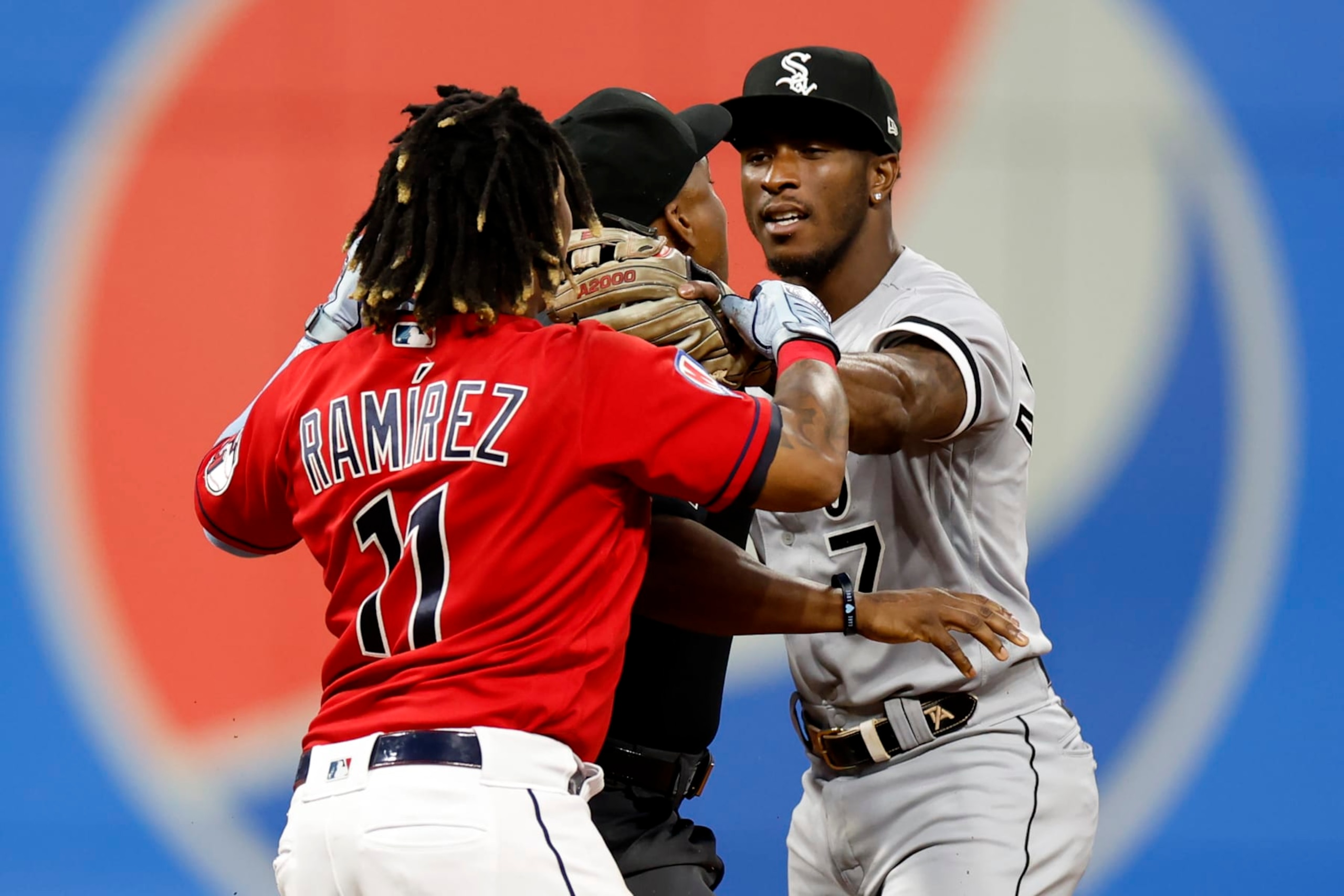 CLEVELAND, OH - AUGUST 05: Jose Ramirez #11 of the Cleveland Guardians and Tim Anderson #7 of the Chicago White Sox start to fight as umpire Malachi Moore #44 gets between them during the sixth inning at Progressive Field on August 05, 2023 in Cleveland, Ohio. (Photo by Ron Schwane/Getty Images)