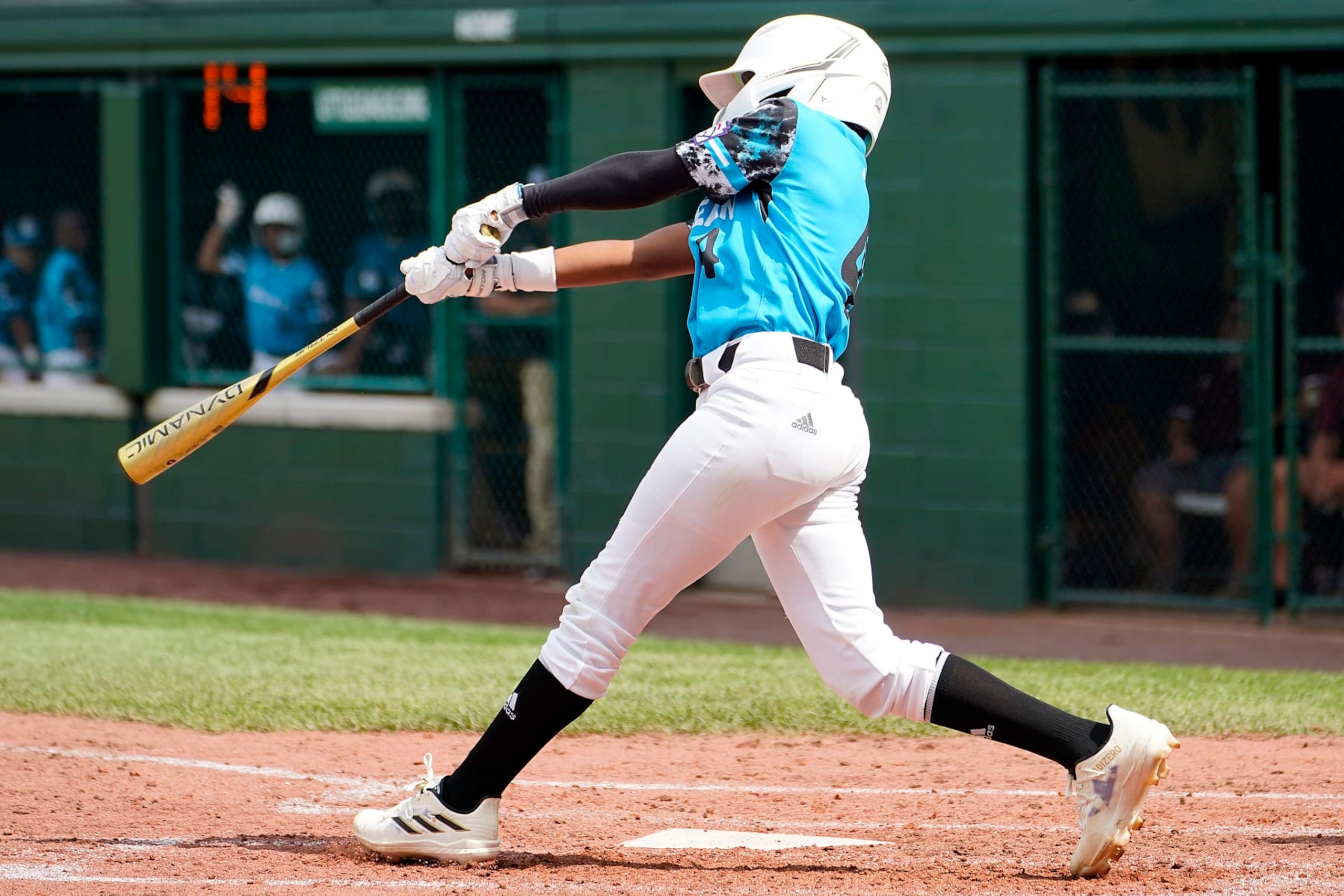 Curacao's Jayvery Felicia (4) follows through on his swing as he drove in the game winning run against Australia during the fifth inning of a baseball game at the Little League World Series tournament in South Williamsport, Pa., Thursday, Aug. 17, 2023. Curacao won the game 2-1. (AP Photo/Tom E. Puskar)