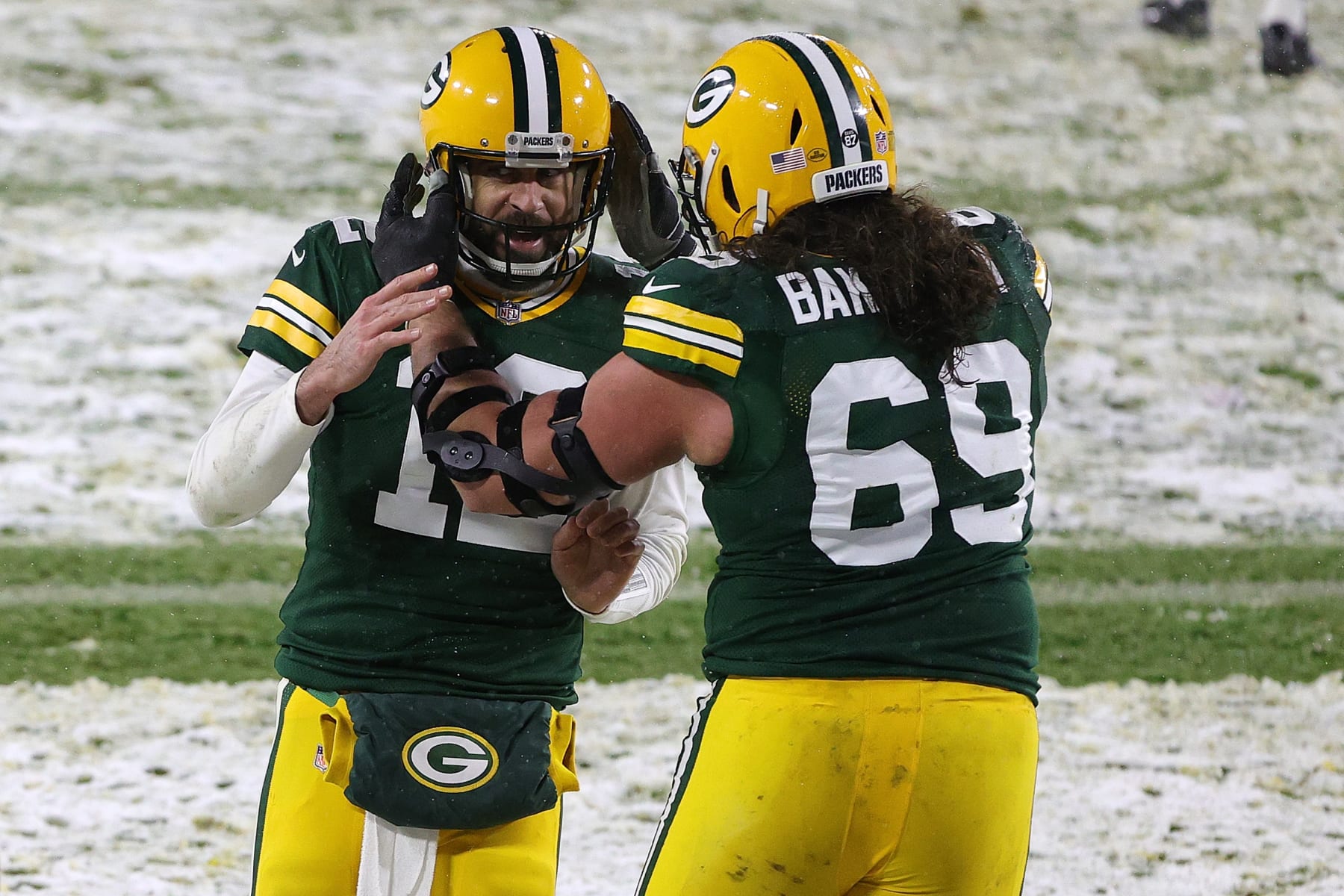 GREEN BAY, WISCONSIN - DECEMBER 27: Aaron Rodgers #12 and David Bakhtiari #69 of the Green Bay Packers celebrate a touchdown during a game against the Tennessee Titans at Lambeau Field on December 27, 2020 in Green Bay, Wisconsin. (Photo by Stacy Revere/Getty Images)