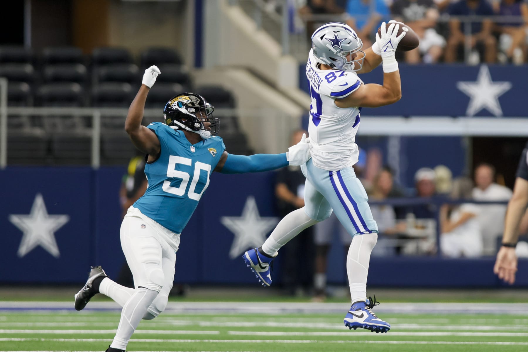 ARLINGTON, TX - AUGUST 12: Dallas Cowboys tight end Jake Ferguson (87) catches the football for a first down during the preseason game between the Dallas Cowboys and the Jacksonville Jaguars on August 12, 2023 at AT&T Stadium in Arlington, Texas. (Photo by Matthew Pearce/Icon Sportswire via Getty Images)