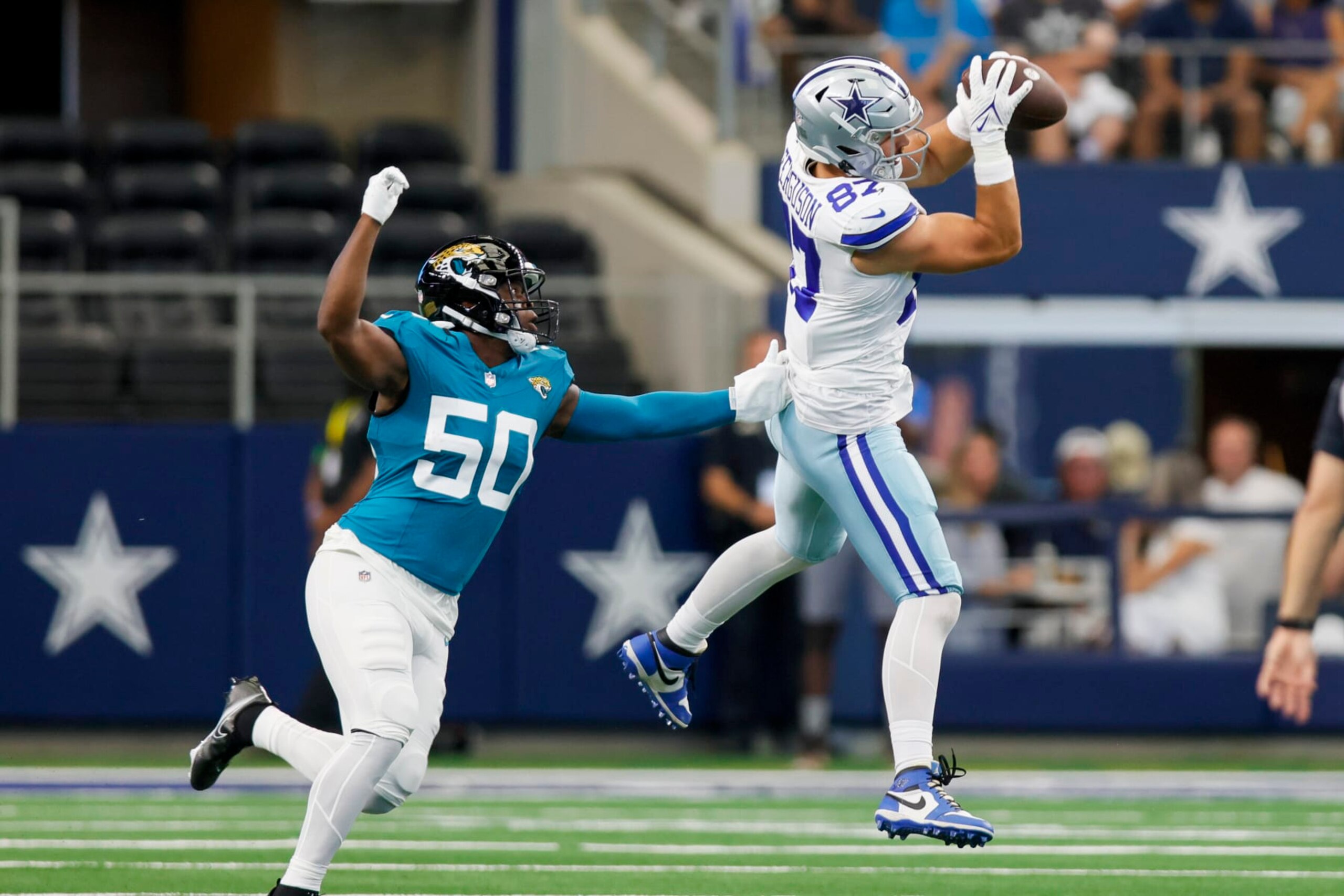 ARLINGTON, TX - AUGUST 12: Dallas Cowboys tight end Jake Ferguson (87) catches the football for a first down during the preseason game between the Dallas Cowboys and the Jacksonville Jaguars on August 12, 2023 at AT&T Stadium in Arlington, Texas. (Photo by Matthew Pearce/Icon Sportswire via Getty Images)