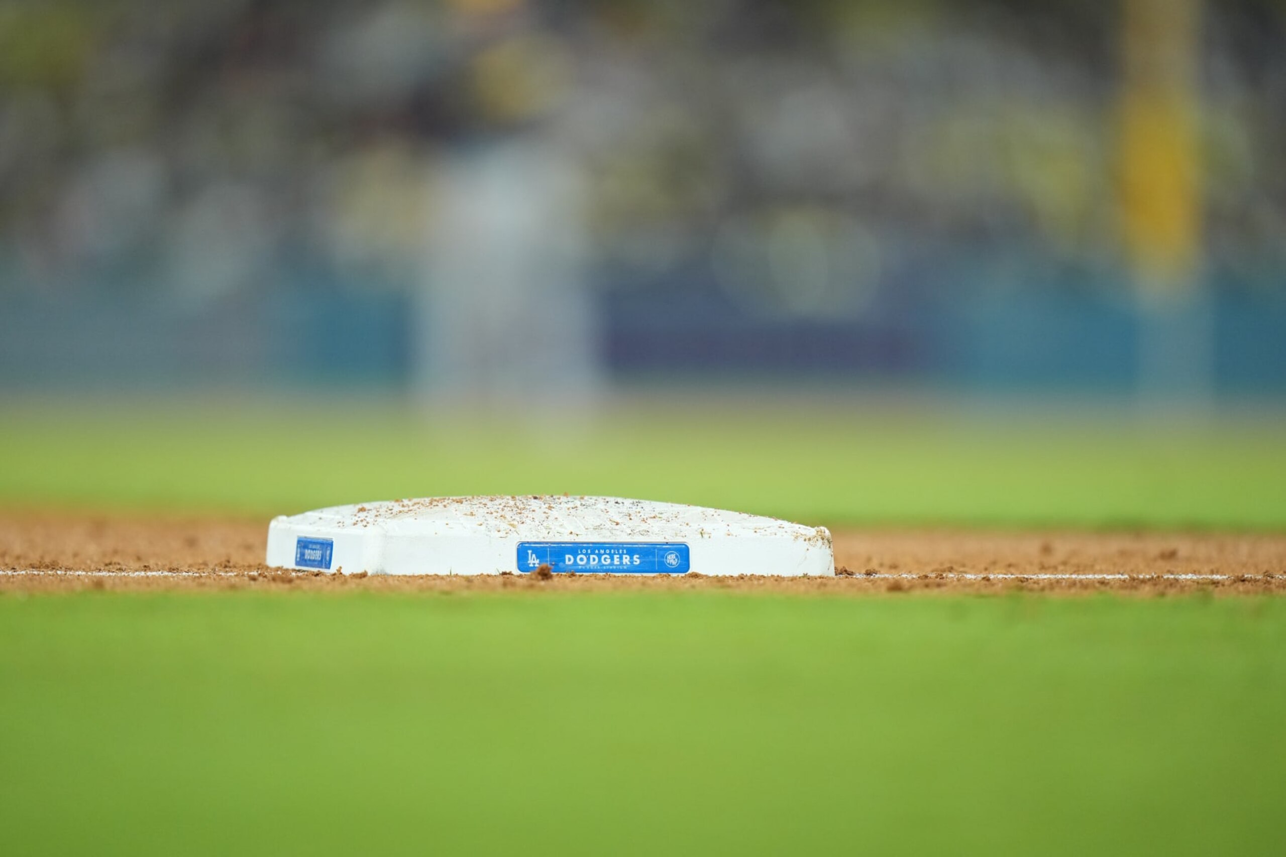 LOS ANGELES, CA - AUGUST 17: The Dodgers logo is seen on the plate at third base during the game between the Milwaukee Brewers and the Los Angeles Dodgers on Thursday, August 17, 2023 at Dodger Stadium, Los Angeles, CA. (Photo by Peter Joneleit/Icon Sportswire via Getty Images)