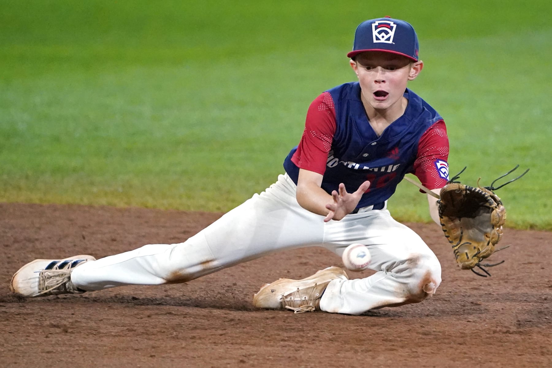Hollidaysburg, Pa. Shortstop Tyler McGough makes a diving stop on a ball hit by Pearland, Texas' Malachi Clark and forces out the runner trying to advance to second base to end the sixth inning of a baseball game at the Little League World Series tournament in South Williamsport, Pa., Wednesday, Aug. 24, 2022. Texas won 8-4. (AP Photo/Tom E. Puskar)