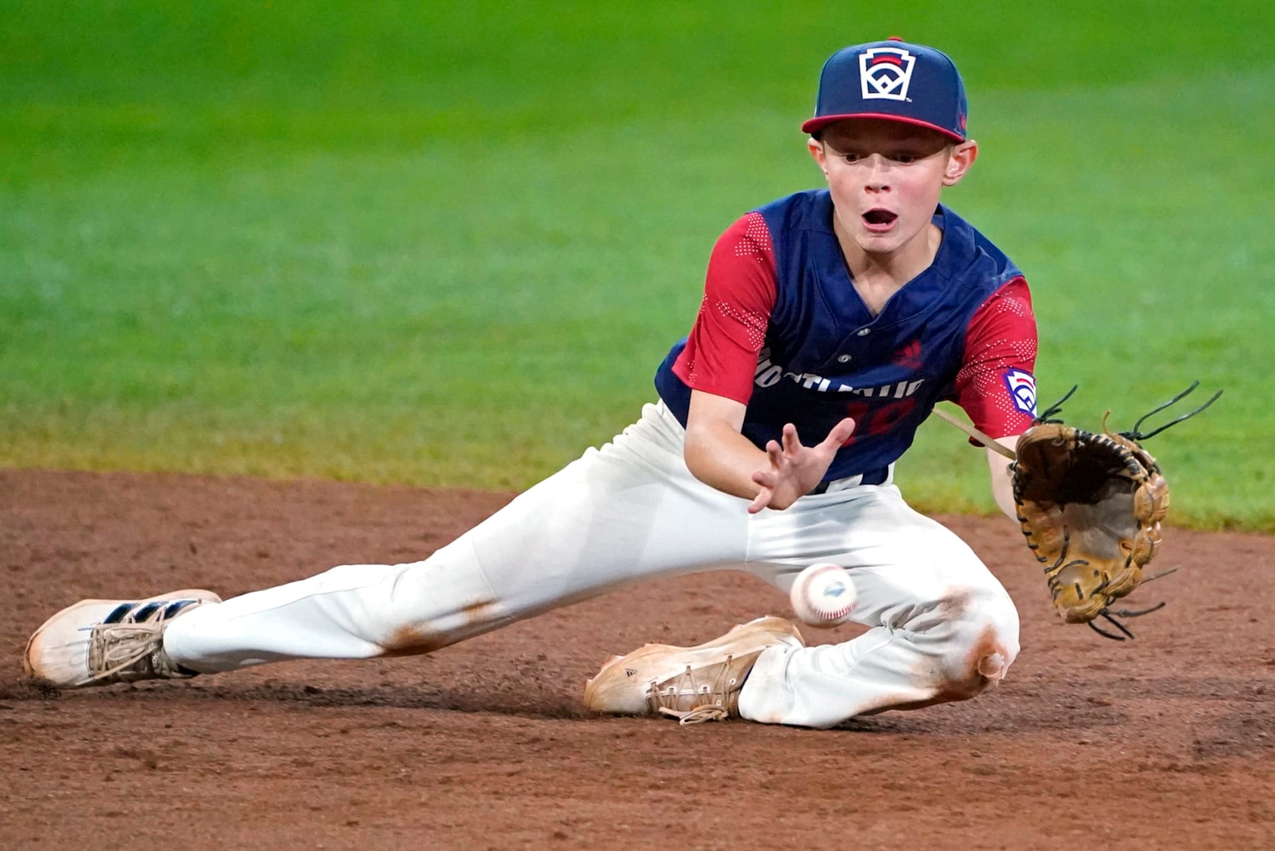 Hollidaysburg, Pa. Shortstop Tyler McGough makes a diving stop on a ball hit by Pearland, Texas' Malachi Clark and forces out the runner trying to advance to second base to end the sixth inning of a baseball game at the Little League World Series tournament in South Williamsport, Pa., Wednesday, Aug. 24, 2022. Texas won 8-4. (AP Photo/Tom E. Puskar)