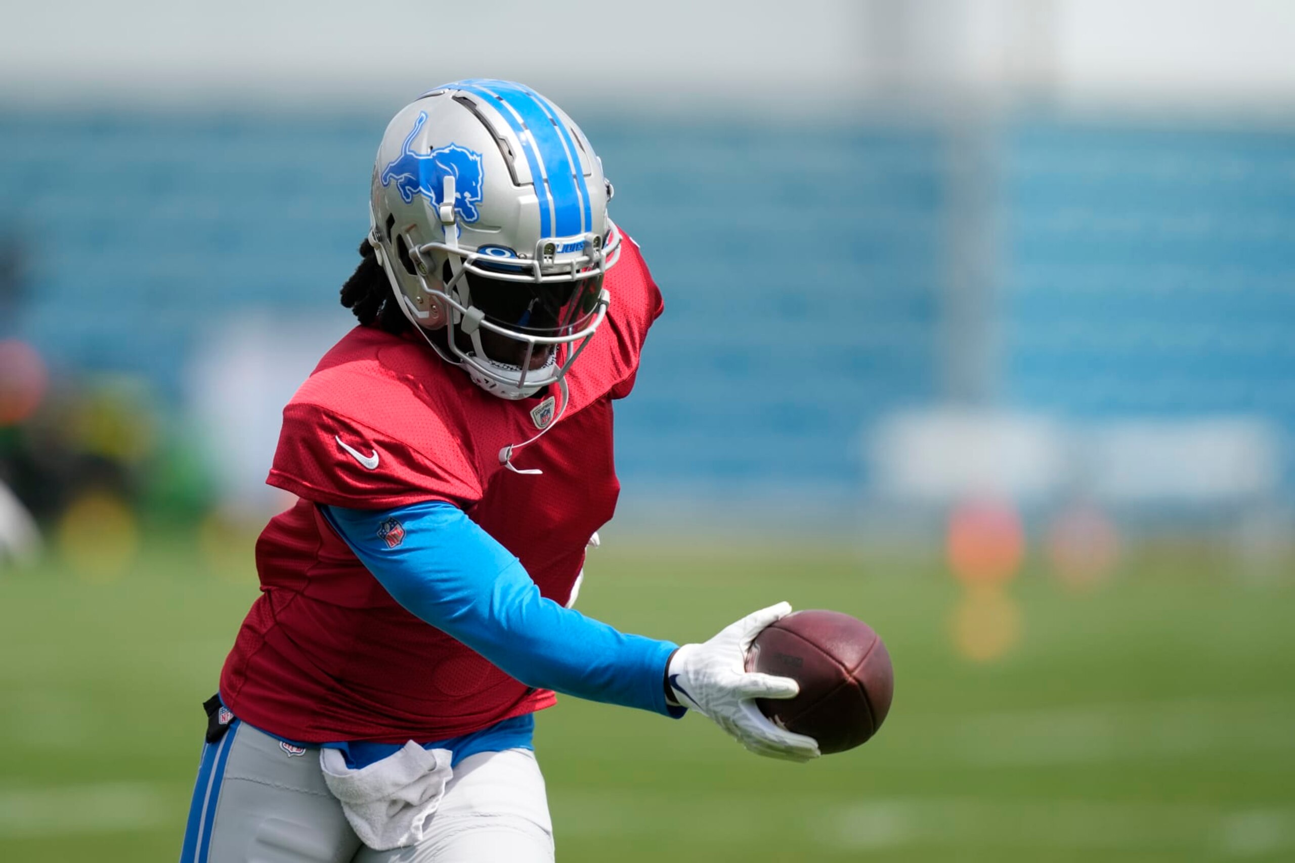Detroit Lions quarterback Teddy Bridgewater hands off during an NFL football practice, Monday, Aug. 14, 2023, in Allen Park, Mich. (AP Photo/Carlos Osorio)