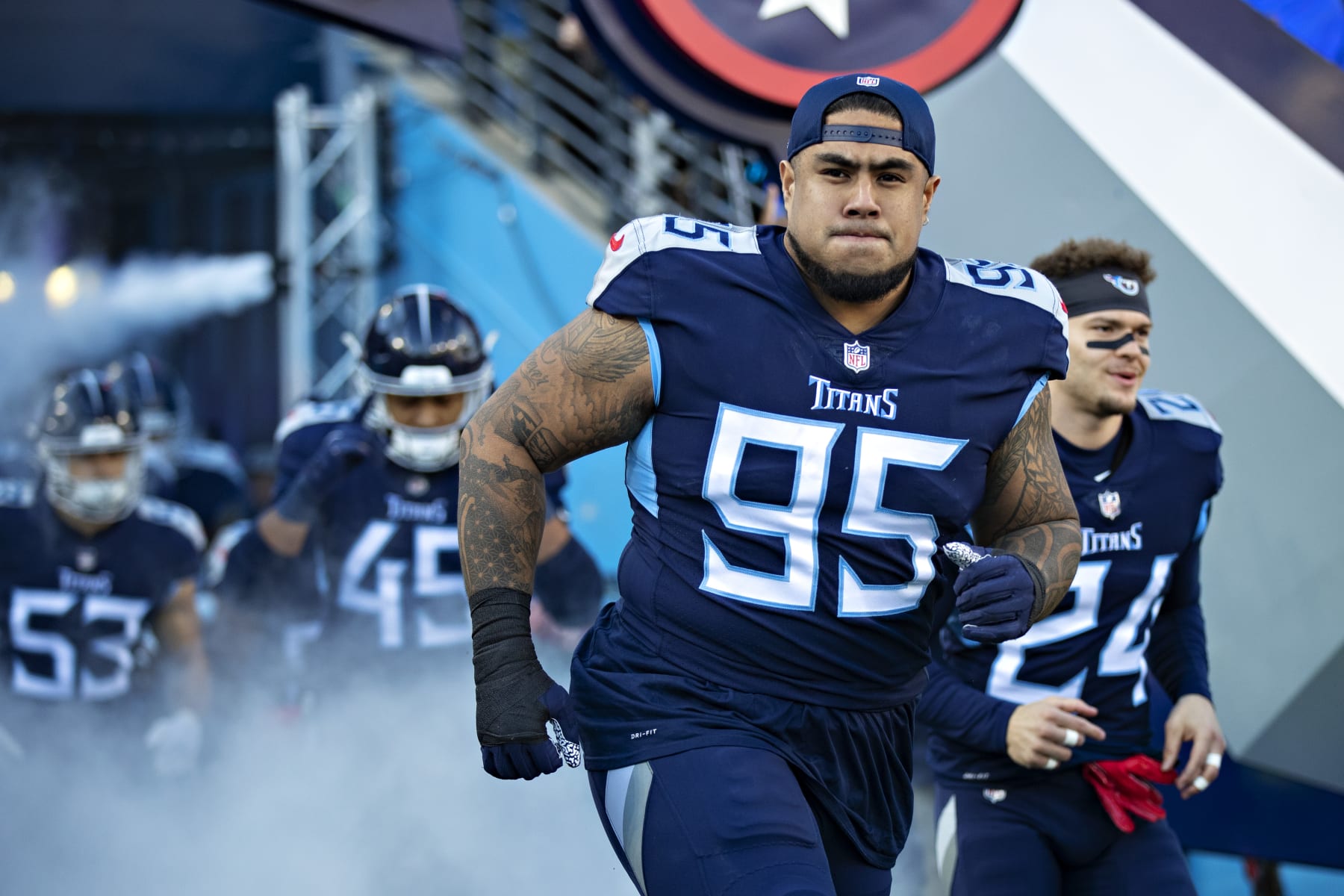 NASHVILLE, TENNESSEE - JANUARY 22: Kyle Peko #95 of the Tennessee Titans runs onto the field during introductions before a game against the Cincinnati Bengals in the AFC Divisional Playoff game at Nissan Stadium on January 22, 2022 in Nashville, Tennessee. The Bengals defeated the Titans 19-16.  (Photo by Wesley Hitt/Getty Images)