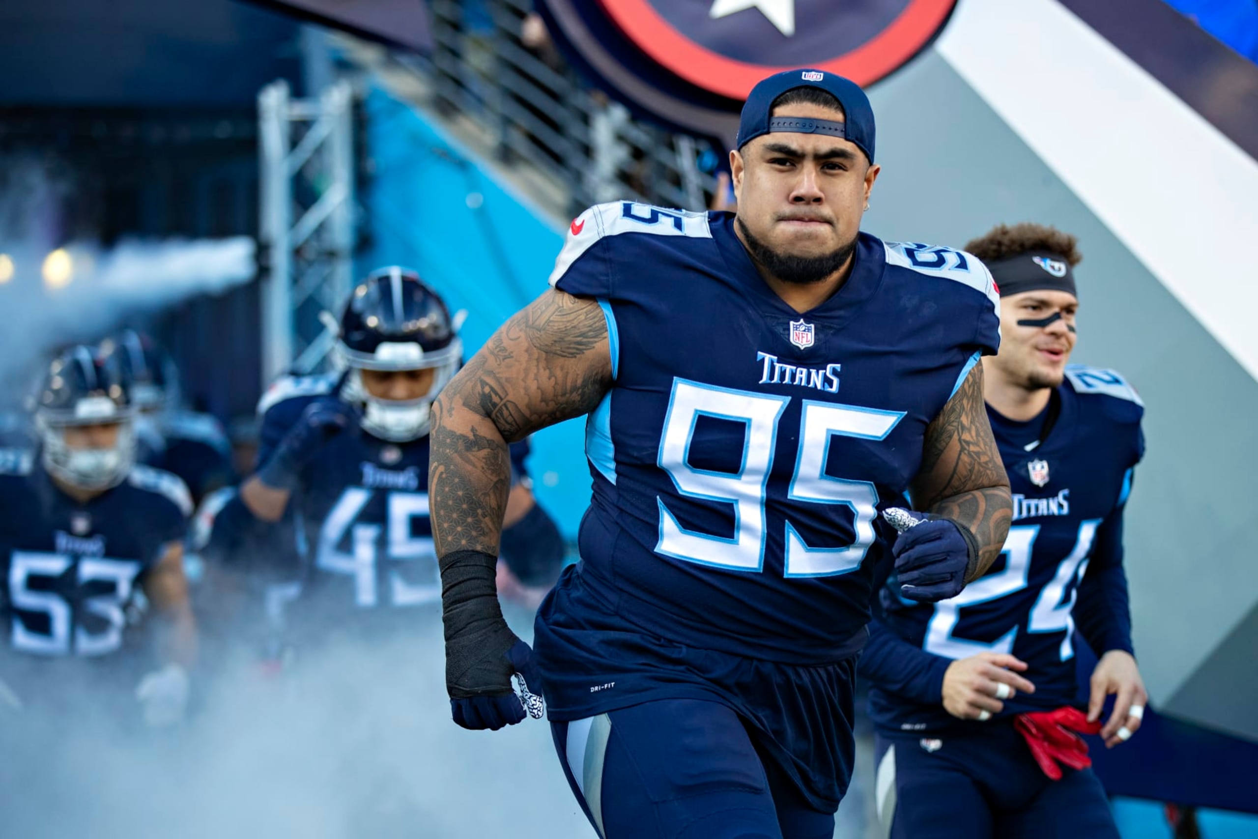 NASHVILLE, TENNESSEE - JANUARY 22: Kyle Peko #95 of the Tennessee Titans runs onto the field during introductions before a game against the Cincinnati Bengals in the AFC Divisional Playoff game at Nissan Stadium on January 22, 2022 in Nashville, Tennessee. The Bengals defeated the Titans 19-16.  (Photo by Wesley Hitt/Getty Images)
