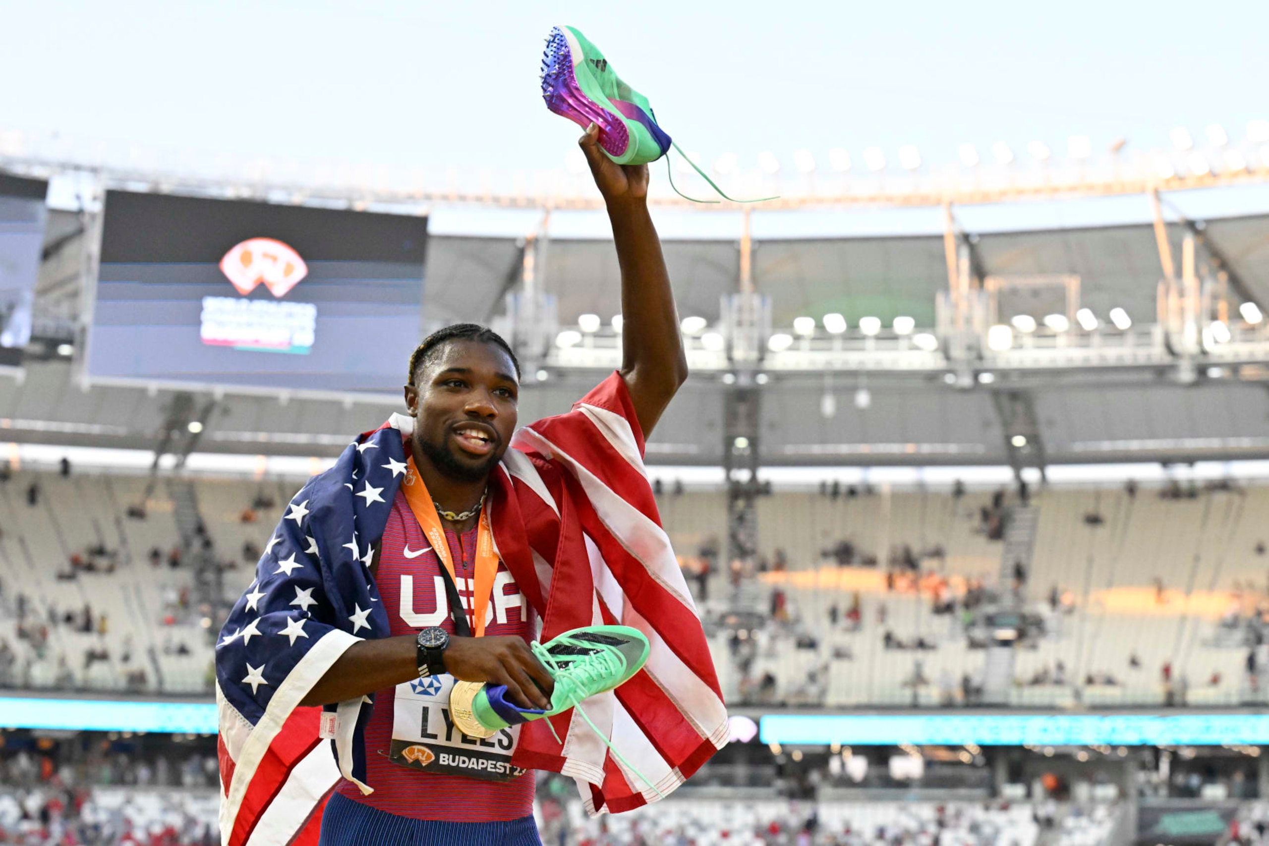 Noah Lyles, of the United States, poses with his gold medal as he celebrates after winning the Men's 100 meters during the World Athletics Championships in Budapest, Hungary, Sunday, Aug. 20, 2023. (AP Photo/Denes Erdos)