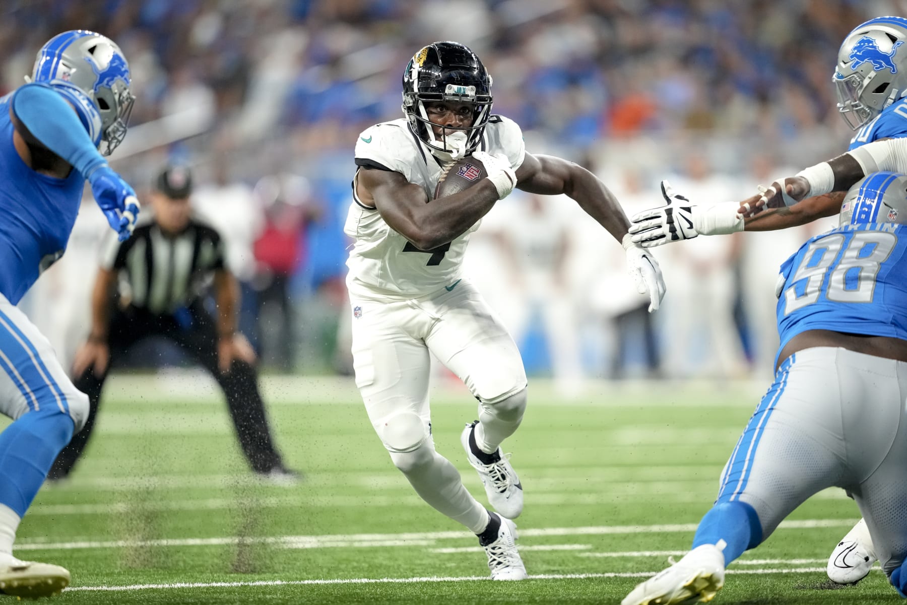 DETROIT, MICHIGAN - AUGUST 19: Tank Bigsby #4 of the Jacksonville Jaguars runs the ball against the Detroit Lions during the second quarter of the preseason game at Ford Field on August 19, 2023 in Detroit, Michigan. (Photo by Nic Antaya/Getty Images)