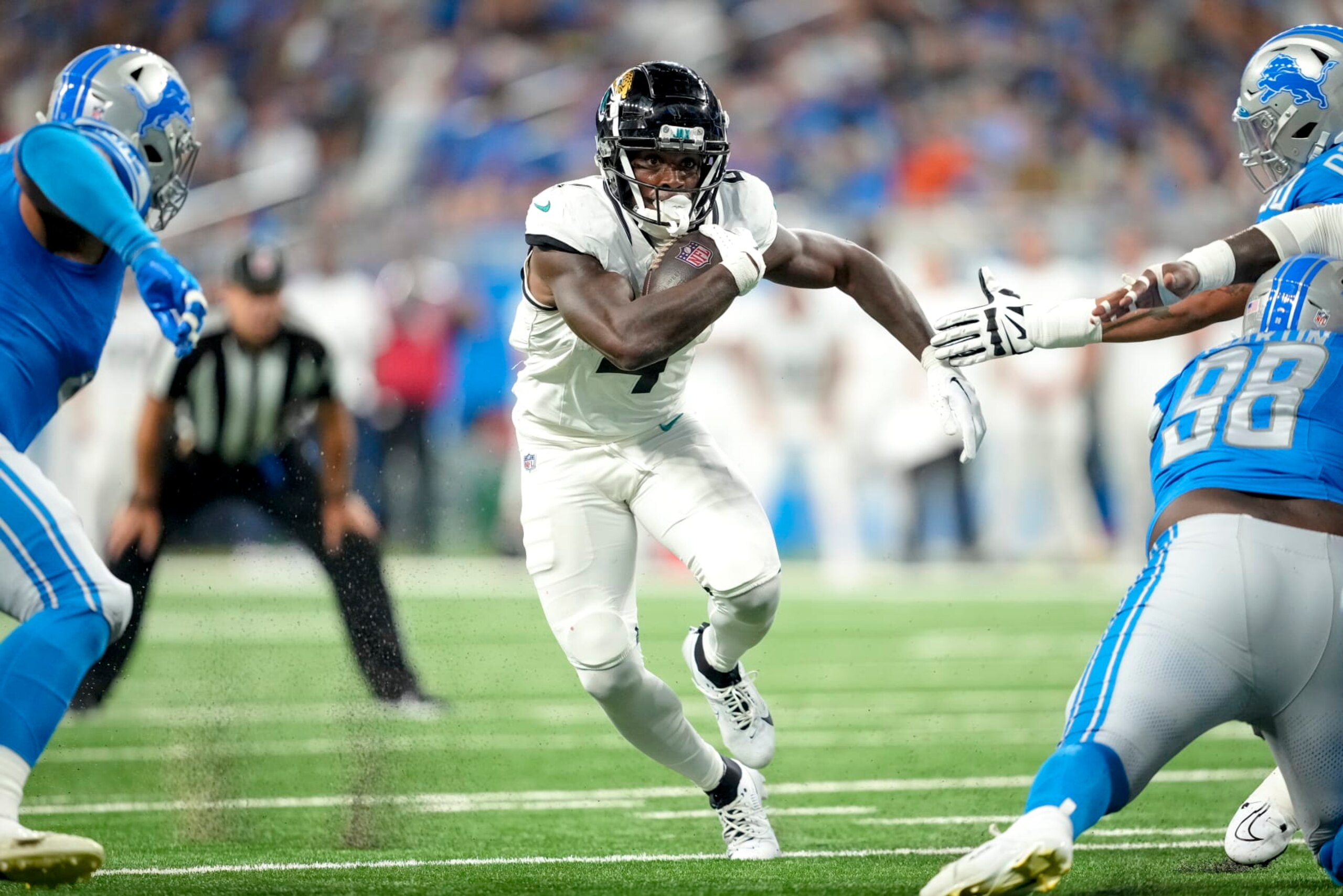 DETROIT, MICHIGAN - AUGUST 19: Tank Bigsby #4 of the Jacksonville Jaguars runs the ball against the Detroit Lions during the second quarter of the preseason game at Ford Field on August 19, 2023 in Detroit, Michigan. (Photo by Nic Antaya/Getty Images) DETROIT, MICHIGAN - AUGUST 19: Tank Bigsby #4 of the Jacksonville Jaguars runs the ball against the Detroit Lions during the second quarter of the preseason game at Ford Field on August 19, 2023 in Detroit, Michigan. (Photo by Nic Antaya/Getty Images)