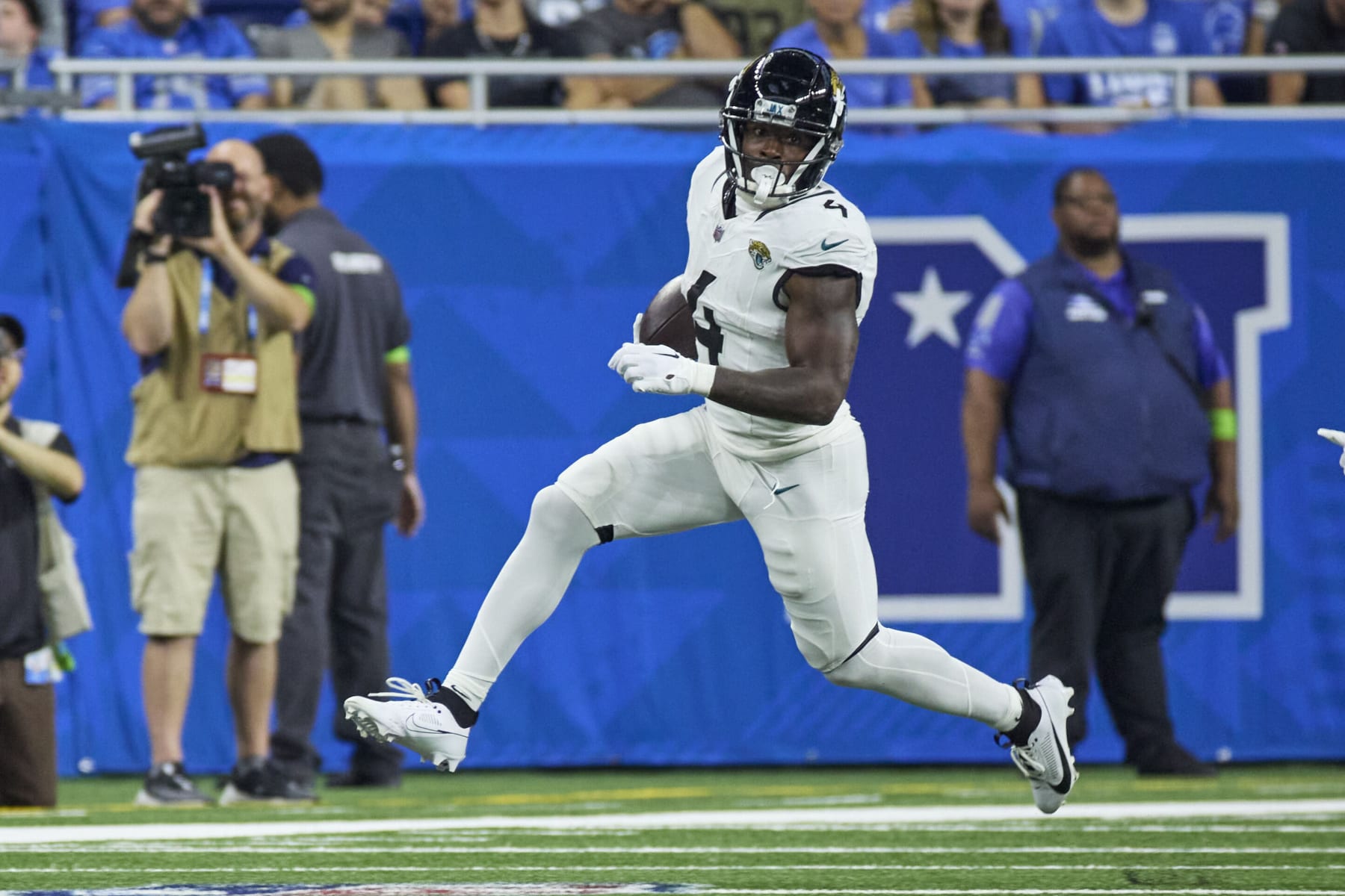 Jacksonville Jaguars running back Tank Bigsby (4) rushes against the Detroit Lions during an NFL pre-season football game, Saturday, Aug. 19, 2023, in Detroit. (AP Photo/Rick Osentoski)