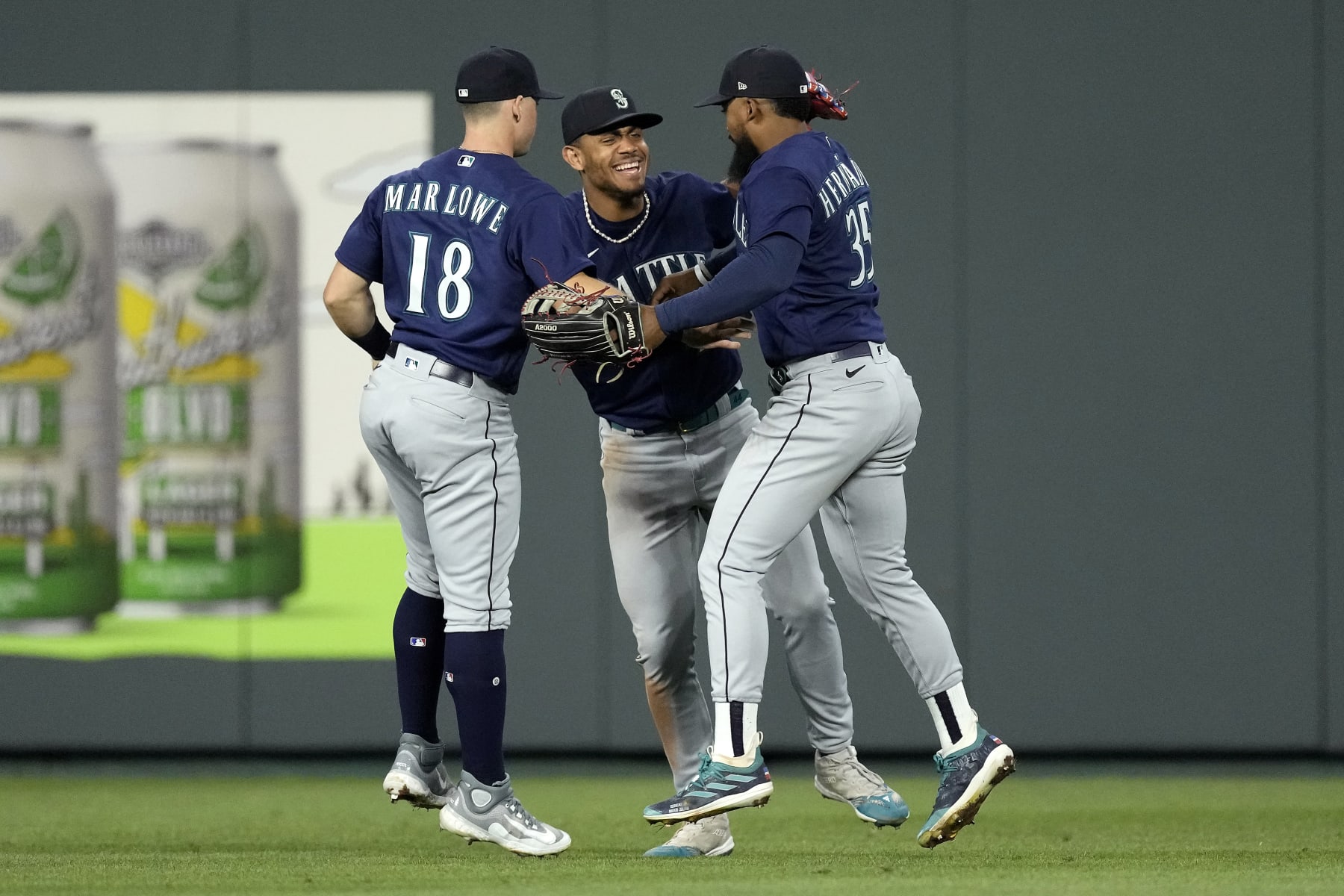 Seattle Mariners' Cade Marlowe (18), Teoscar Hernandez (35) and Julio Rodriguez, center, celebrate after their baseball game against the Kansas City Royals Wednesday, Aug. 16, 2023, in Kansas City, Mo. The Seattle Mariners won 6-5. (AP Photo/Charlie Riedel)