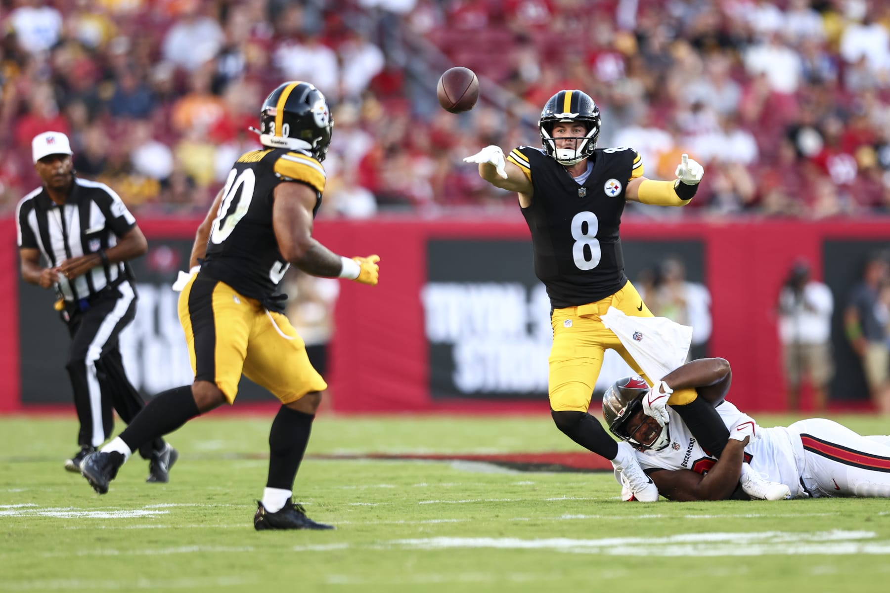 TAMPA, FL - AUGUST 11: Kenny Pickett #8 of the Pittsburgh Steelers avoids a sack by Mike Greene #91 of the Tampa Bay Buccaneers during the first quarter of an NFL preseason football game at Raymond James Stadium on August 11, 2023 in Tampa, Florida. (Photo by Kevin Sabitus/Getty Images)