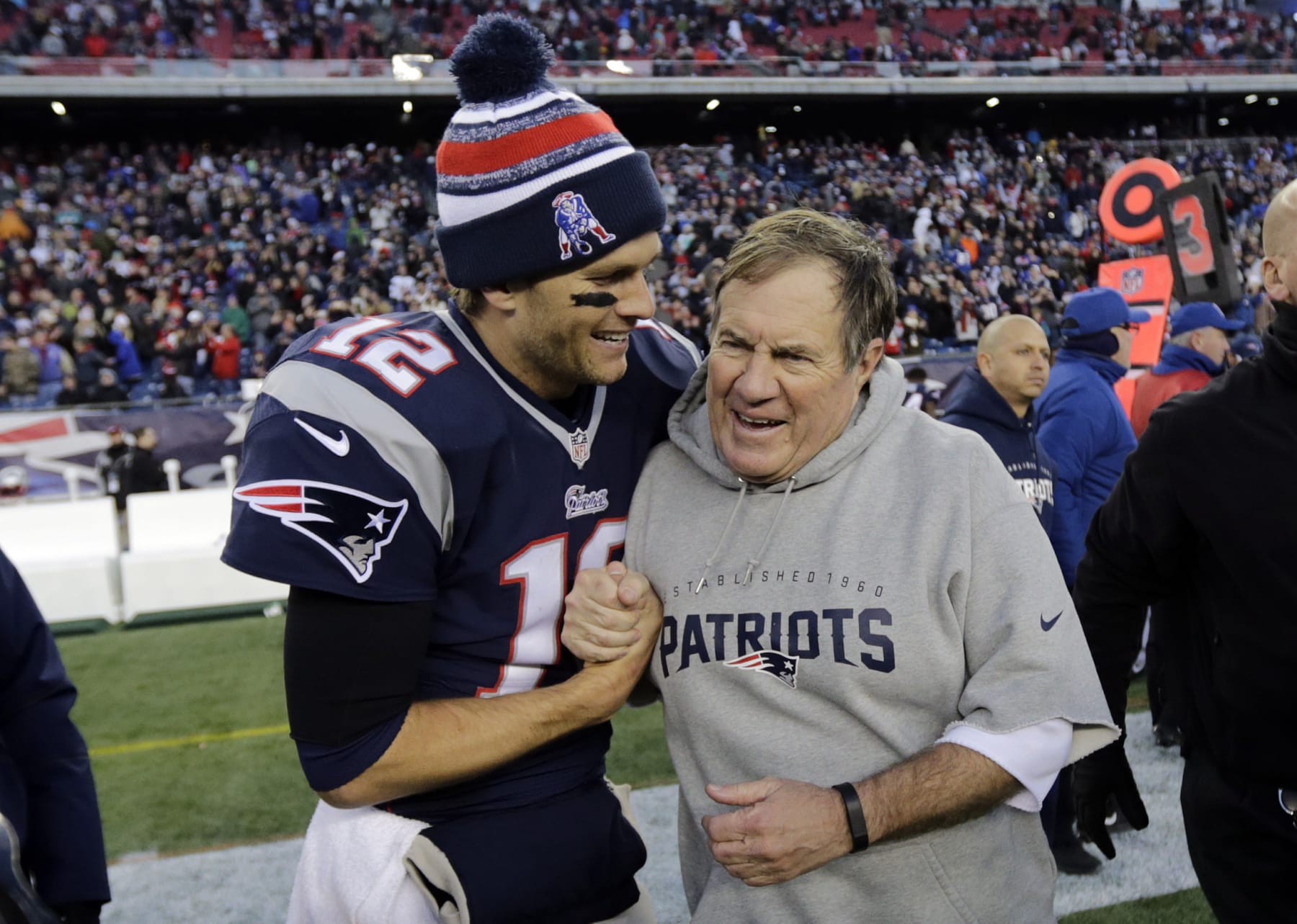 FILE - New England Patriots quarterback Tom Brady, left, celebrates with head coach Bill Belichick after defeating the Miami Dolphins 41-13 in an NFL football game Sunday, Dec. 14, 2014, in Foxborough, Mass. Tom Brady has retired after winning seven Super Bowls and setting numerous passing records in an unprecedented 22-year-career. He made the announcement, Tuesday, Feb. 1, 2022, in a long post on Instagram. (AP Photo/Charles Krupa, File)