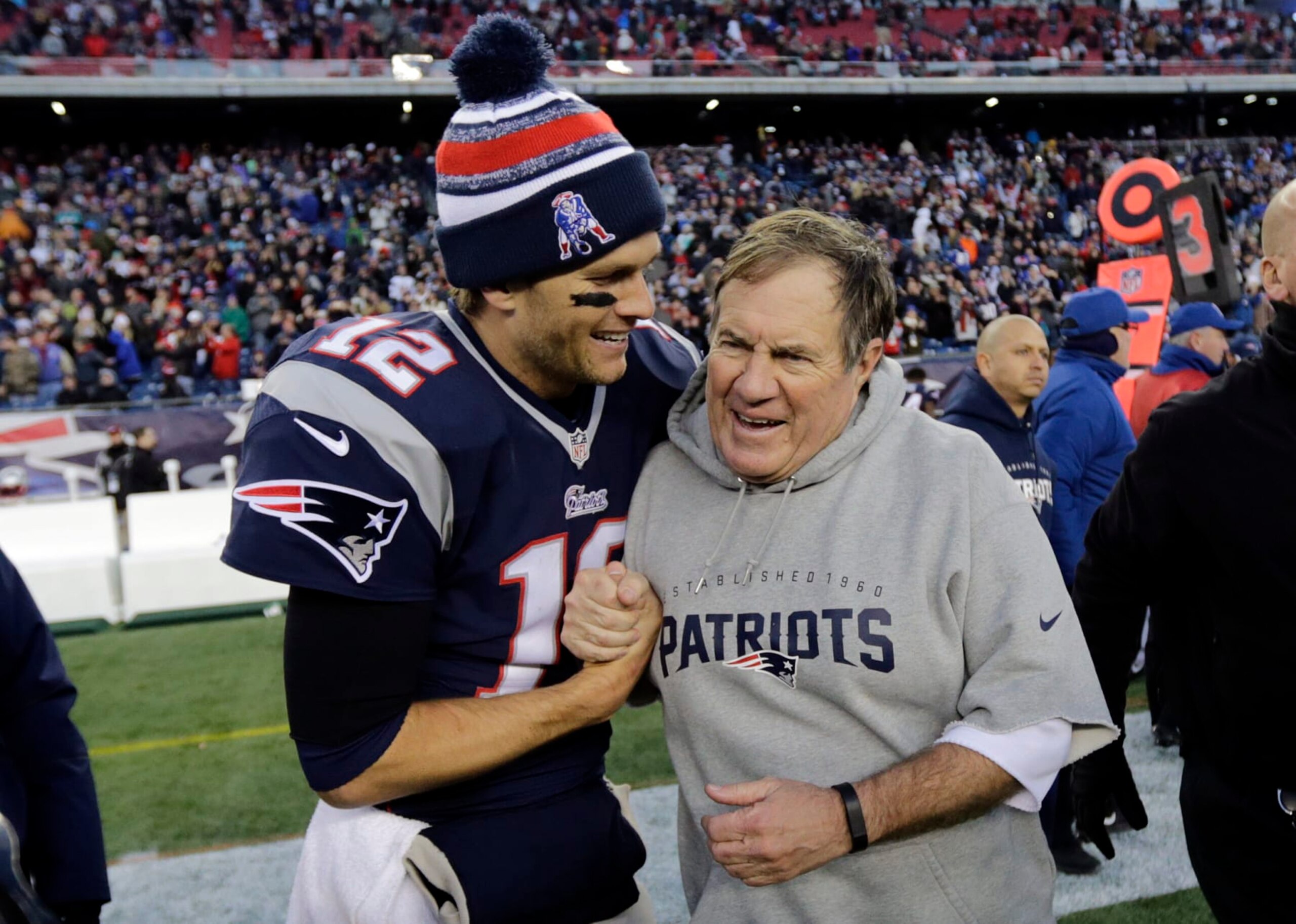 FILE - New England Patriots quarterback Tom Brady, left, celebrates with head coach Bill Belichick after defeating the Miami Dolphins 41-13 in an NFL football game Sunday, Dec. 14, 2014, in Foxborough, Mass. Tom Brady has retired after winning seven Super Bowls and setting numerous passing records in an unprecedented 22-year-career. He made the announcement, Tuesday, Feb. 1, 2022, in a long post on Instagram. (AP Photo/Charles Krupa, File)