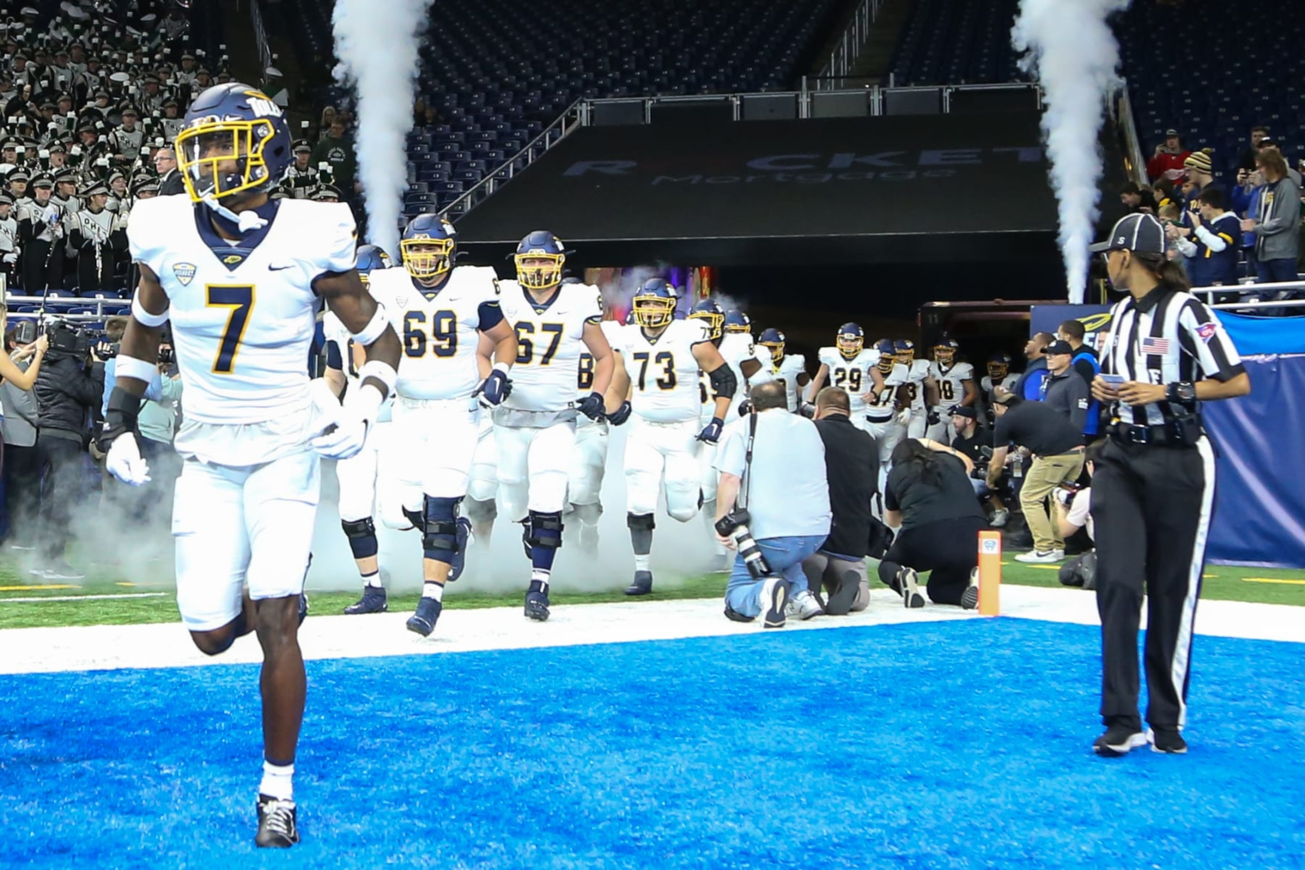 DETROIT, MI - DECEMBER 03:  Toledo Rockets quarterback Dequan Finn (7) and his teammates run onto the field before the start of the Mid-American Conference college football championship game between the Toledo Rockets and the Ohio Bobcats on December 3, 2022 at Ford Field in Detroit, Michigan.  (Photo by Scott W. Grau/Icon Sportswire via Getty Images)