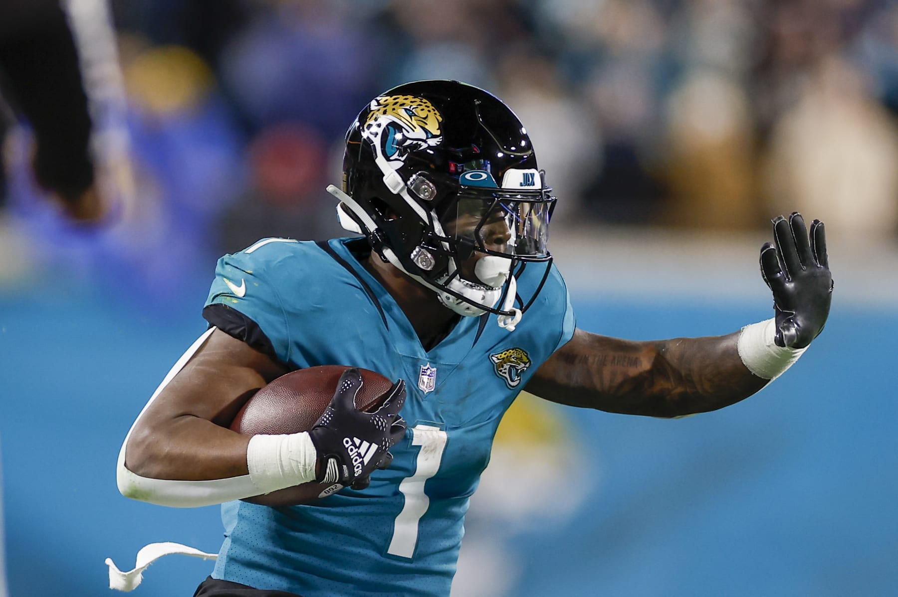 JACKSONVILLE, FL - JANUARY 14:Jacksonville Jaguars running back Travis Etienne Jr. (1) runs with the ball  during the game between the Los Angeles Chargers and the Jacksonville Jaguars on January 14, 2023 at TIAA Bank Field in Jacksonville, Fl. (Photo by David Rosenblum/Icon Sportswire via Getty Images)