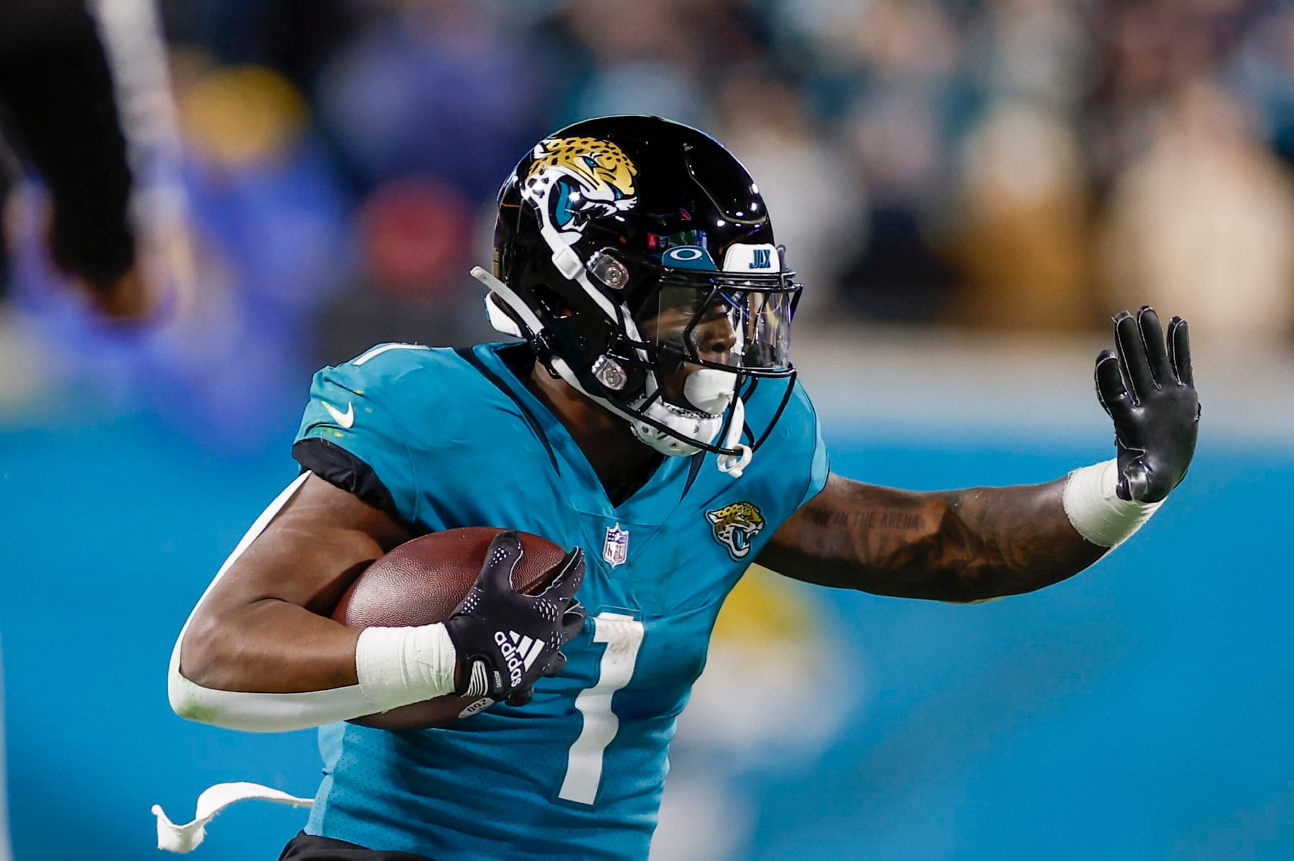 JACKSONVILLE, FL - JANUARY 14:Jacksonville Jaguars running back Travis Etienne Jr. (1) runs with the ball during the game between the Los Angeles Chargers and the Jacksonville Jaguars on January 14, 2023 at TIAA Bank Field in Jacksonville, Fl. (Photo by David Rosenblum/Icon Sportswire via Getty Images) JACKSONVILLE, FL - JANUARY 14:Jacksonville Jaguars running back Travis Etienne Jr. (1) runs with the ball during the game between the Los Angeles Chargers and the Jacksonville Jaguars on January 14, 2023 at TIAA Bank Field in Jacksonville, Fl. (Photo by David Rosenblum/Icon Sportswire via Getty Images)