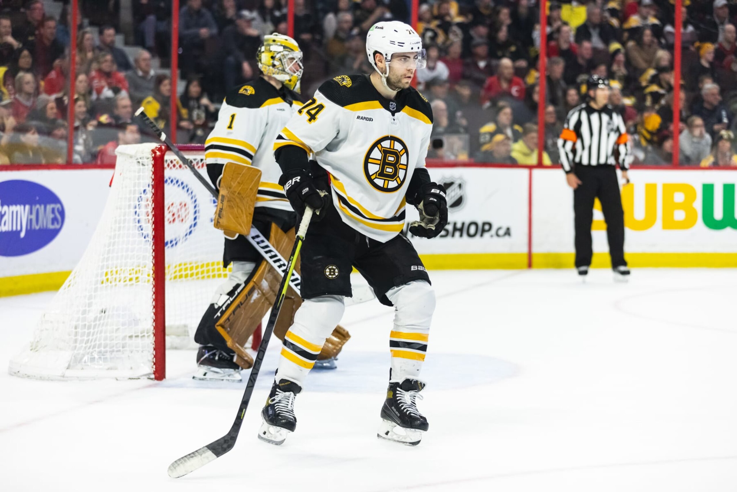 OTTAWA, ON - DECEMBER 27: Boston Bruins Right Wing Jake DeBrusk (74) helps defend the net of Goalie Jeremy Swayman (1) during overtime National Hockey League action between the Boston Bruins and Ottawa Senators on December 27, 2022, at Canadian Tire Centre in Ottawa, ON, Canada. (Photo by Richard A. Whittaker/Icon Sportswire via Getty Images)