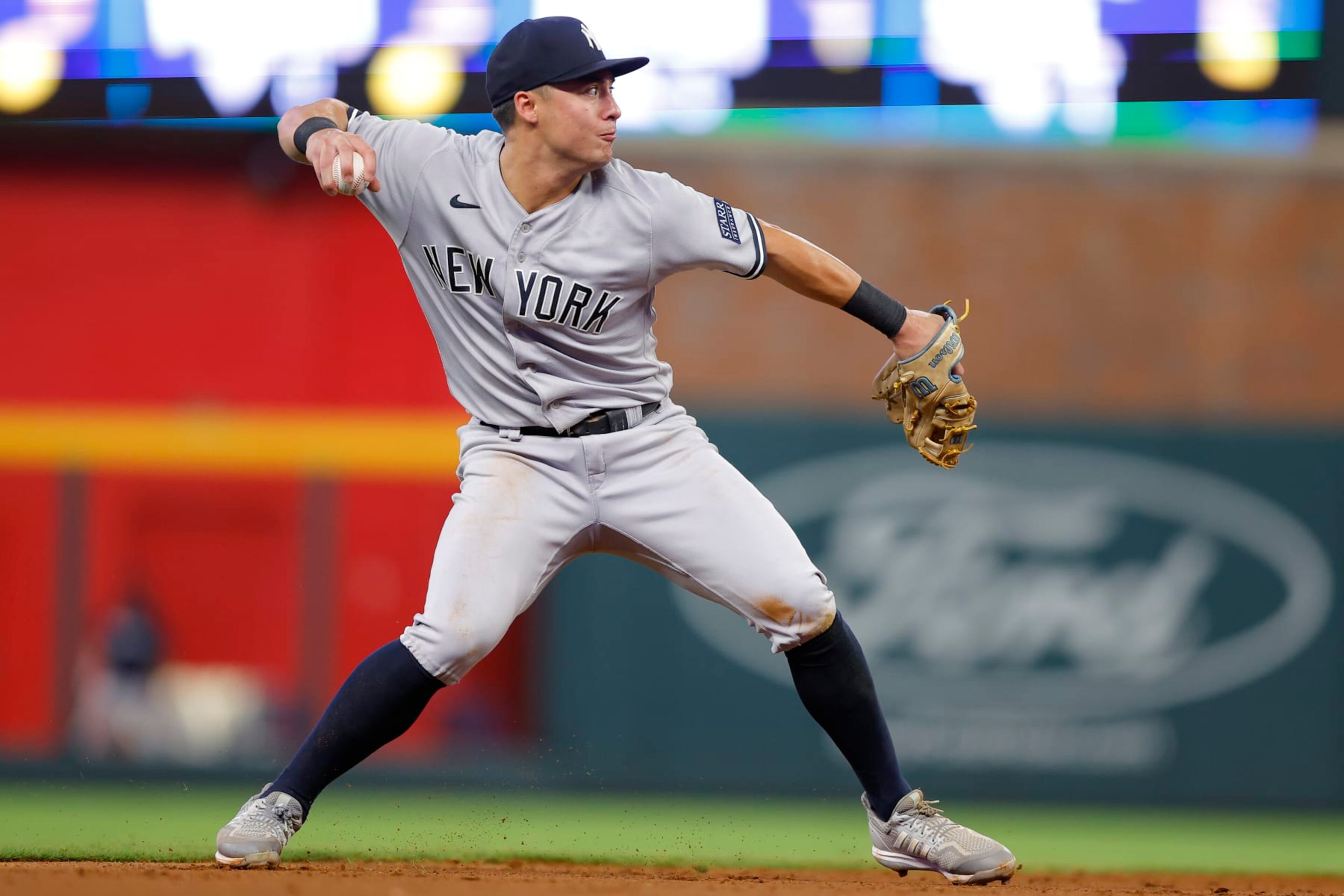 ATLANTA, GEORGIA - AUGUST 15: Anthony Volpe #11 of the New York Yankees throws to first base during the sixth inning against the Atlanta Braves at Truist Park on August 15, 2023 in Atlanta, Georgia. (Photo by Todd Kirkland/Getty Images)