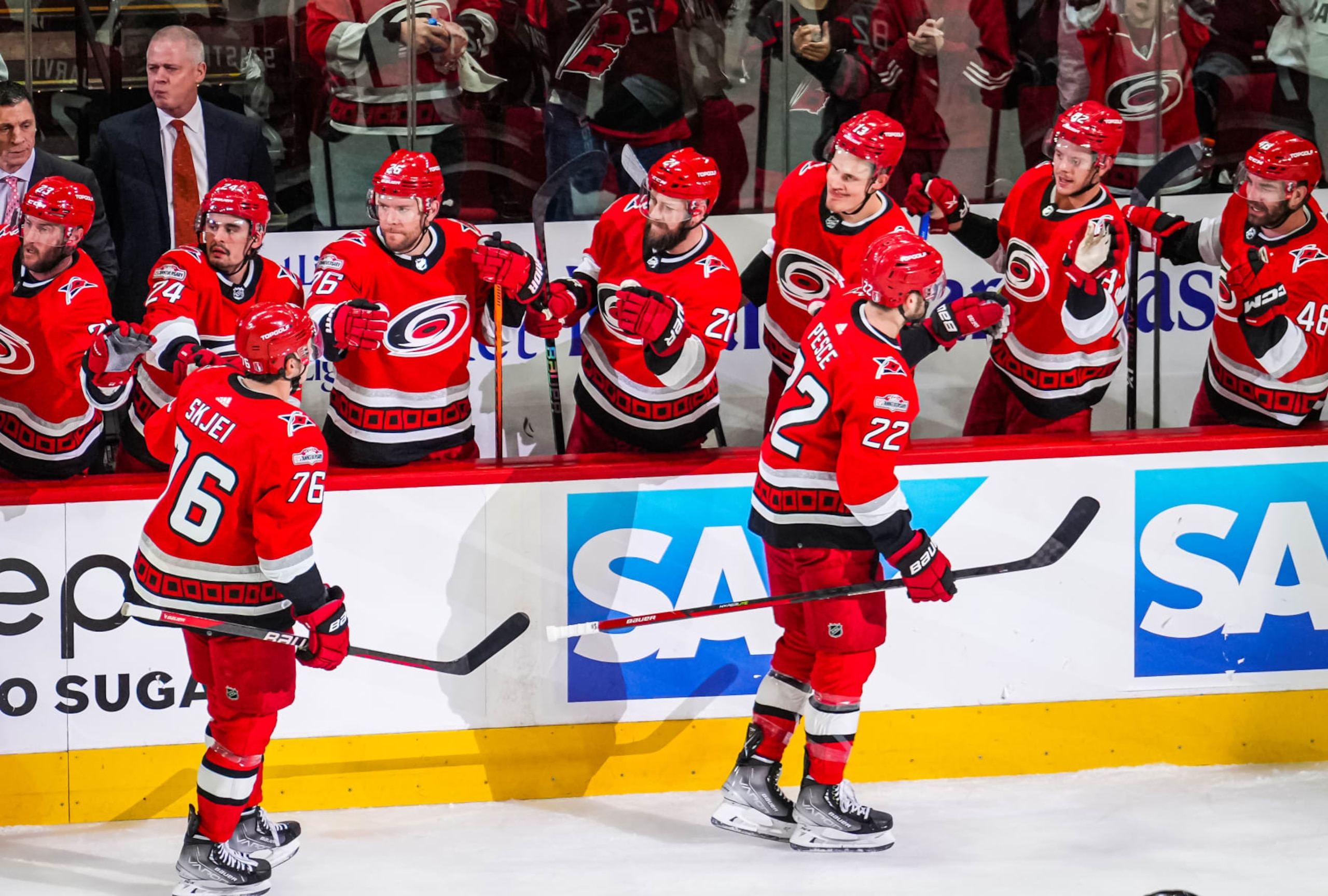 RALEIGH, NORTH CAROLINA - MAY 03: Brett Pesce #22 of the Carolina Hurricanes celebrates with teammates after a goal during the first period against the New Jersey Devils in Game One of the Second Round of the 2023 Stanley Cup Playoffs at PNC Arena on May 03, 2023 in Raleigh, North Carolina. (Photo by Cato Cataldo/NHLI via Getty Images)