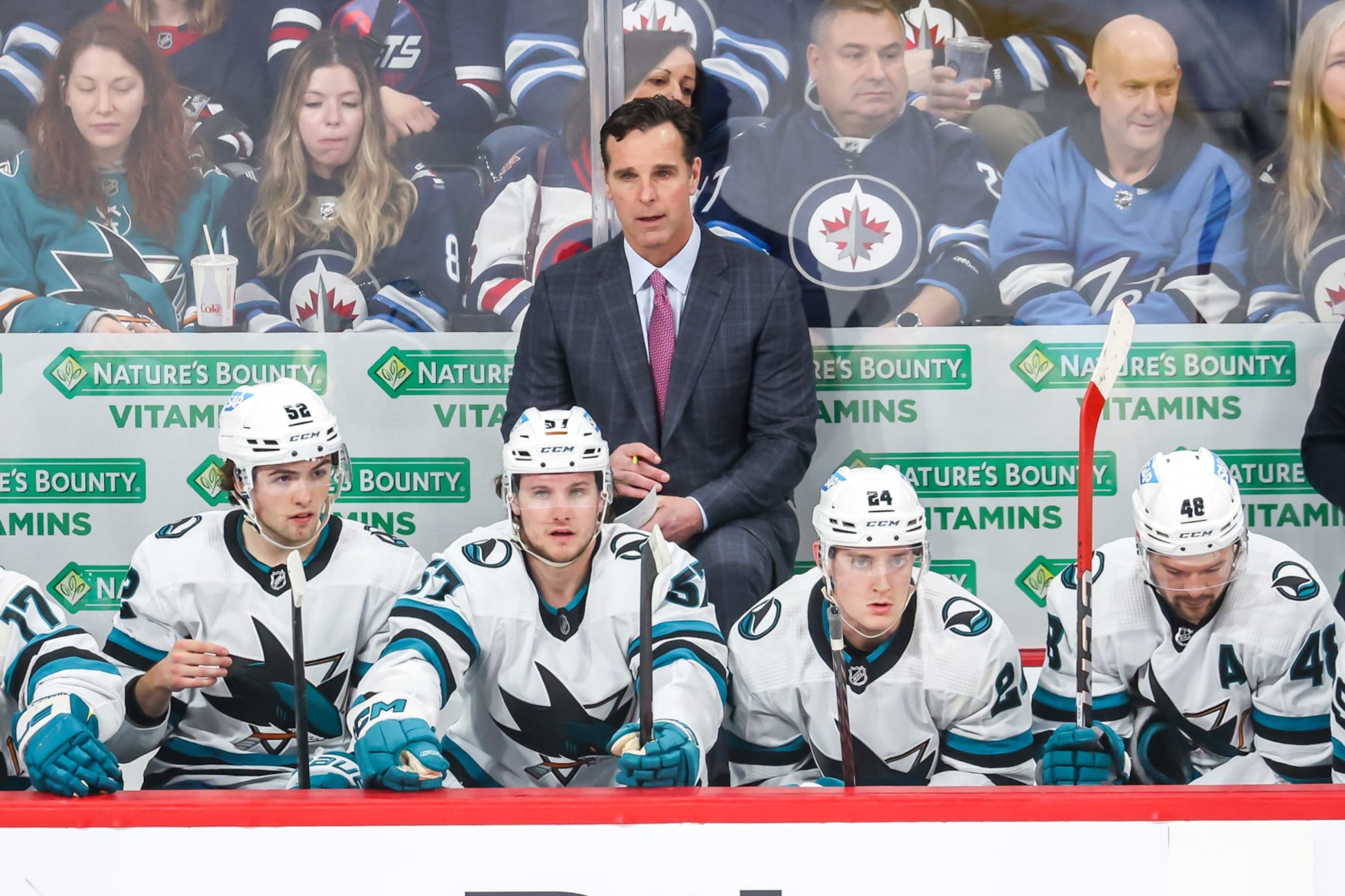 WINNIPEG, CANADA - APRIL 10: Head Coach David Quinn of the San Jose Sharks looks on from the bench during first period action against the Winnipeg Jets at the Canada Life Centre on April 10, 2023 in Winnipeg, Manitoba, Canada. (Photo by Jonathan Kozub/NHLI via Getty Images)